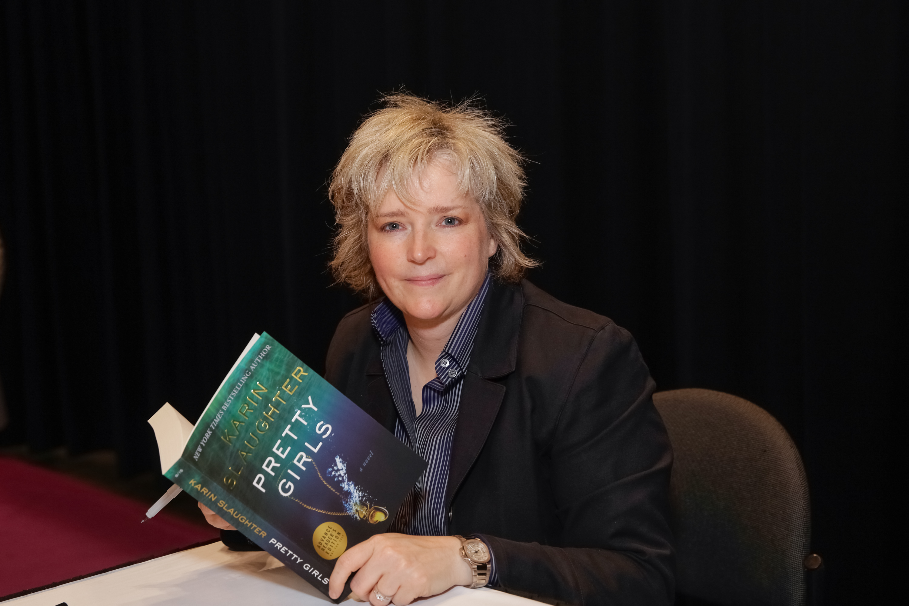 Author Karin Slaughter poses for photographs with her newest book during BookExpo America in New York City on May 27, 2015.