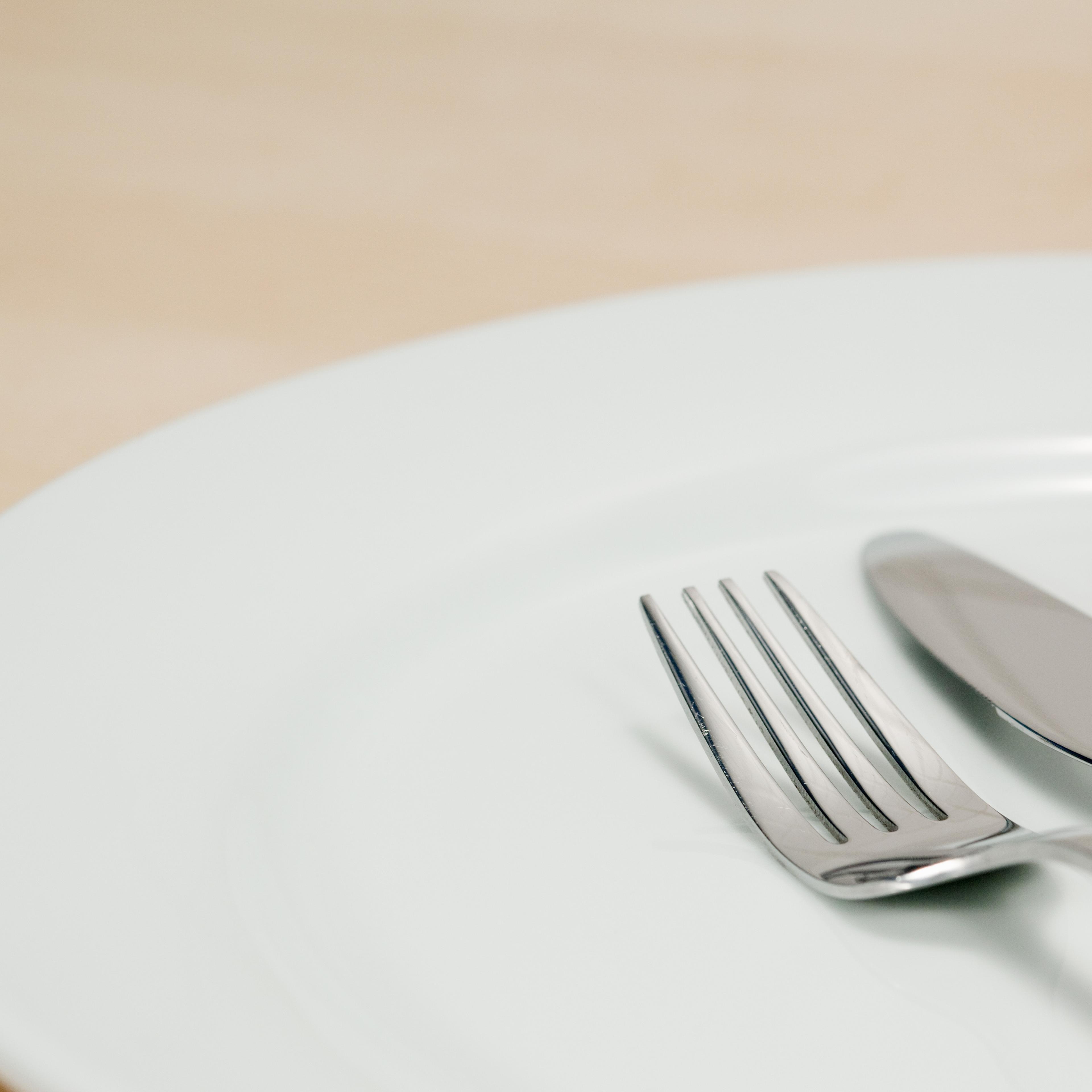 Empty plate with knife and fork