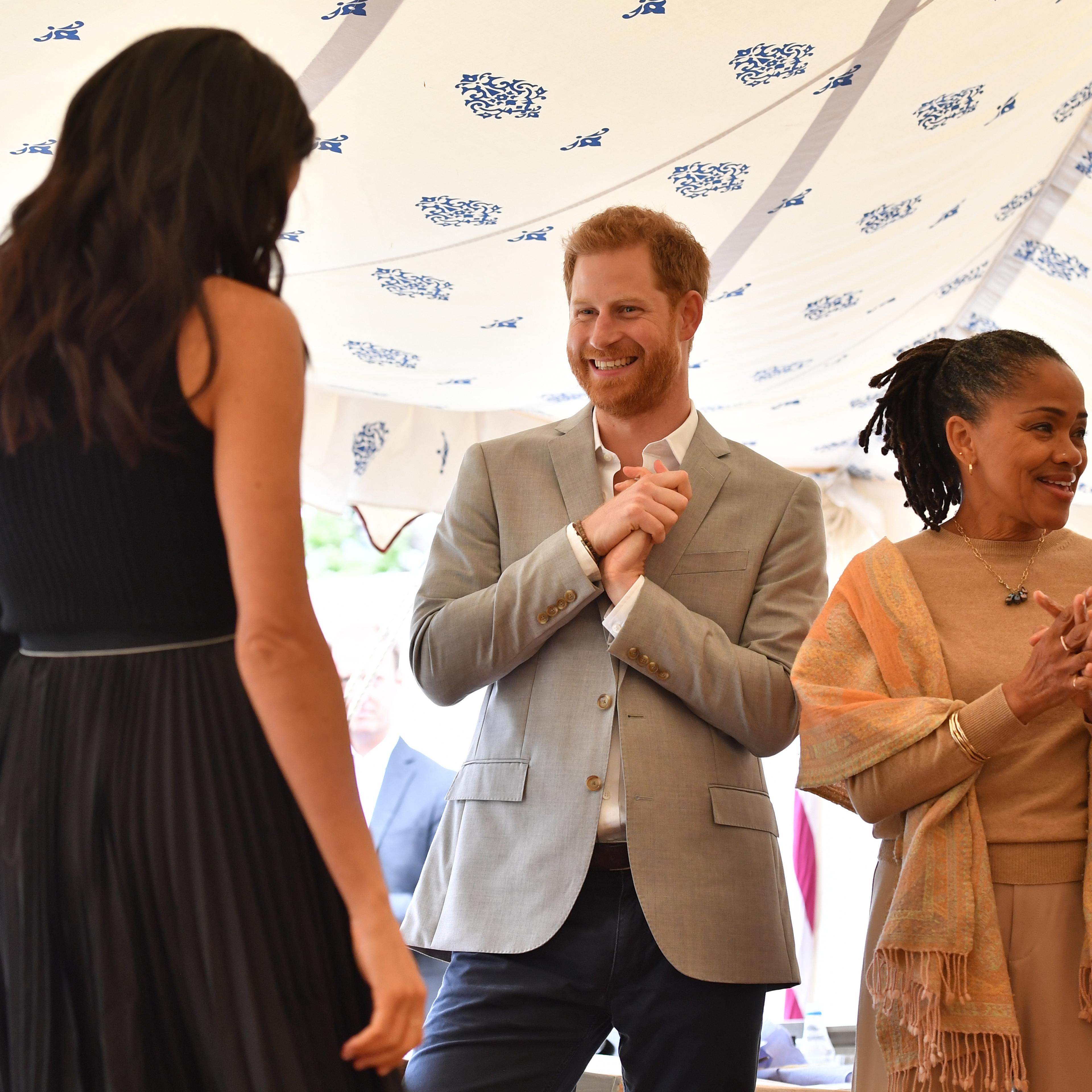Prince Harry steals snack at Meghan's party