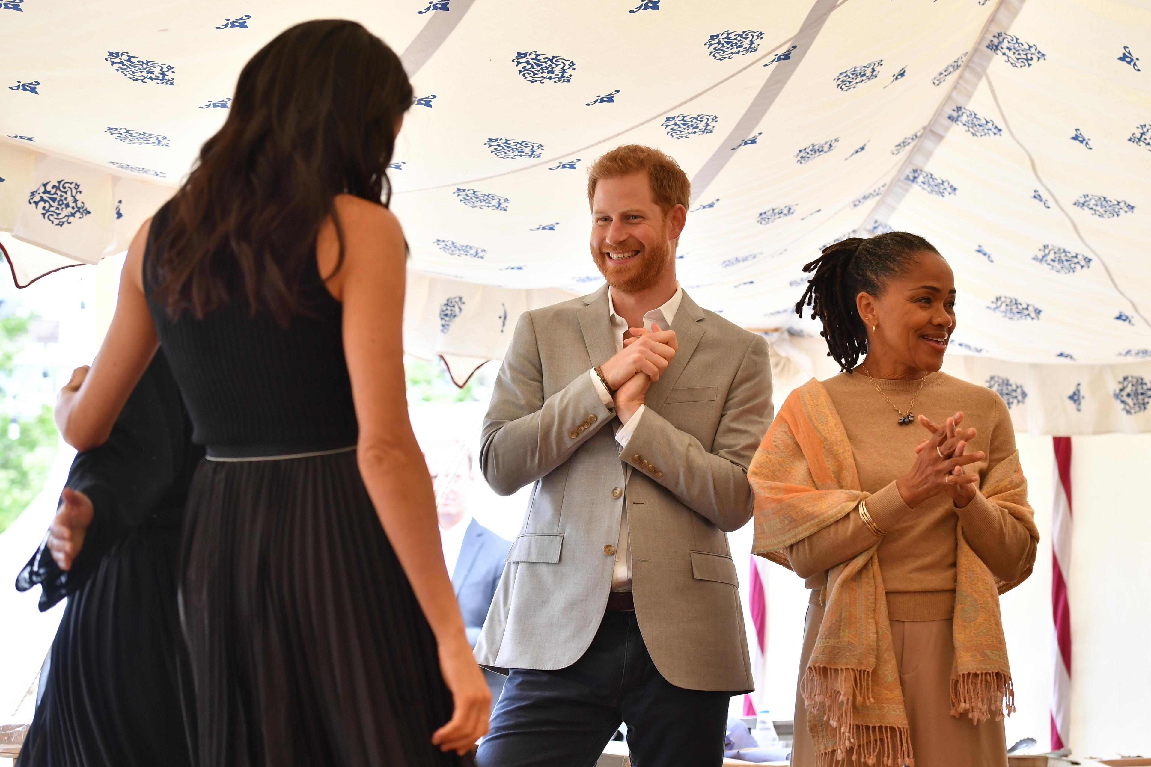 Prince Harry steals snack at Meghan's party