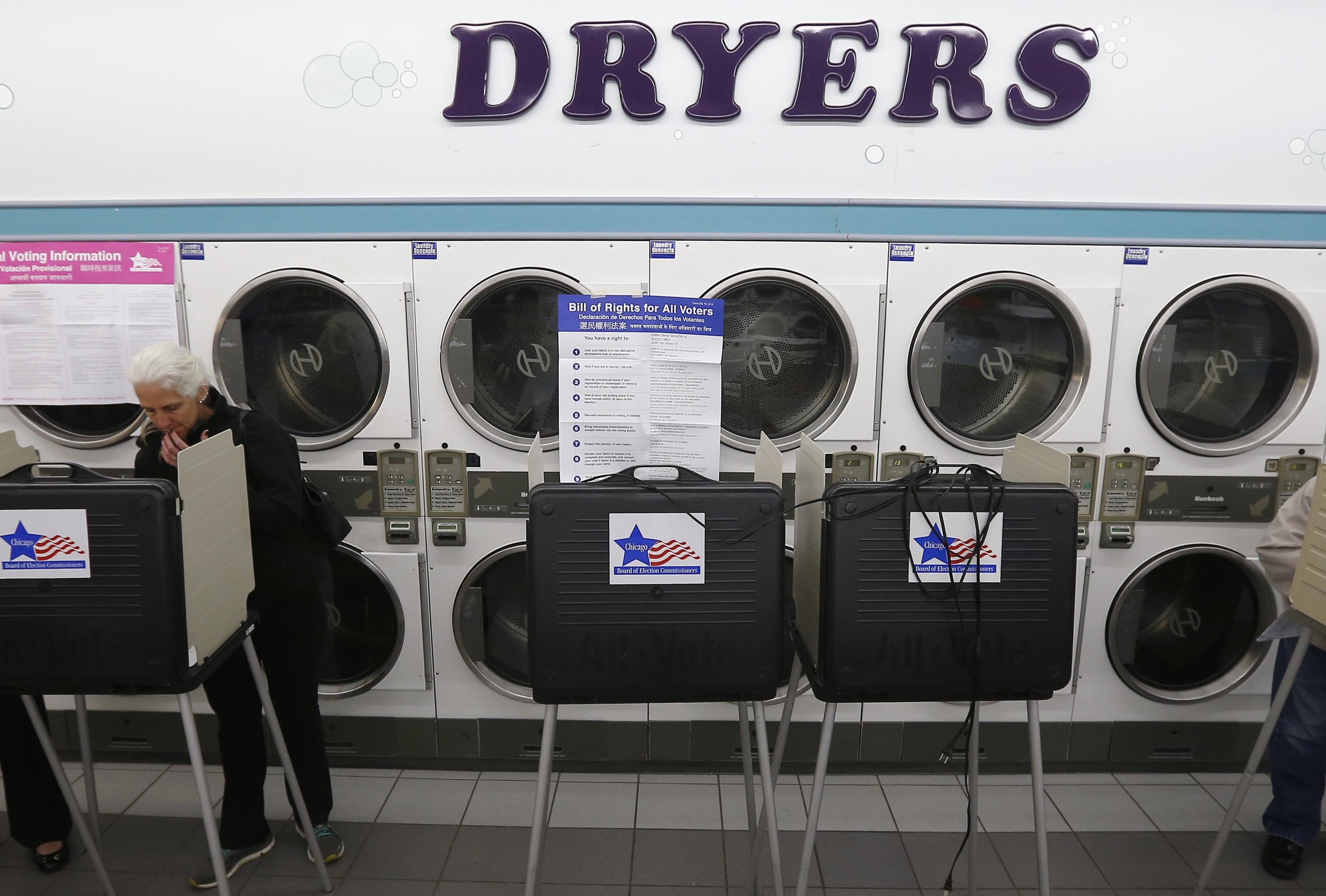 A voter looks over her ballot for the U.S. midterm elections at a laundromat used as a polling station in Chicago, Illinois