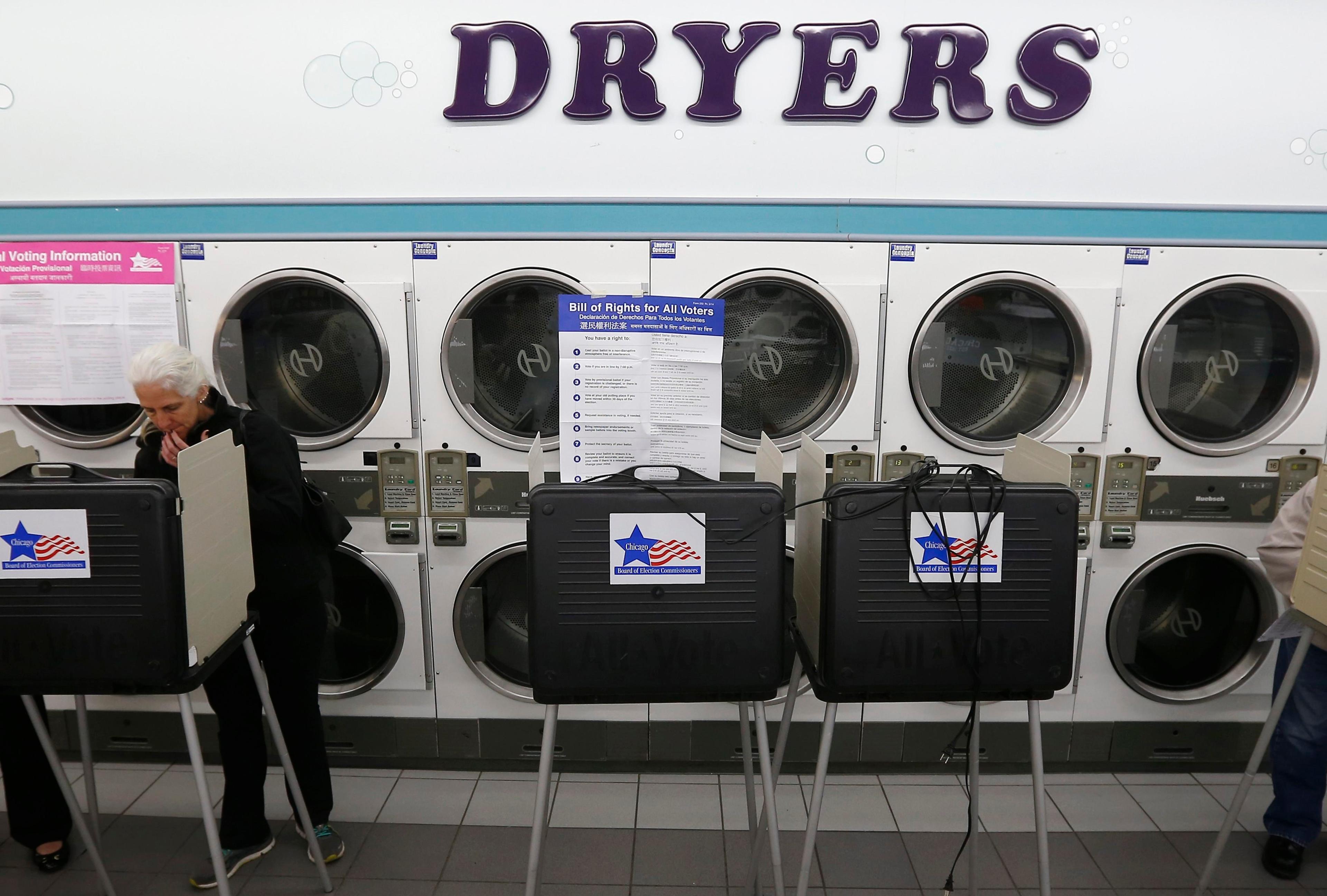 A voter looks over her ballot for the U.S. midterm elections at a laundromat used as a polling station in Chicago, Illinois