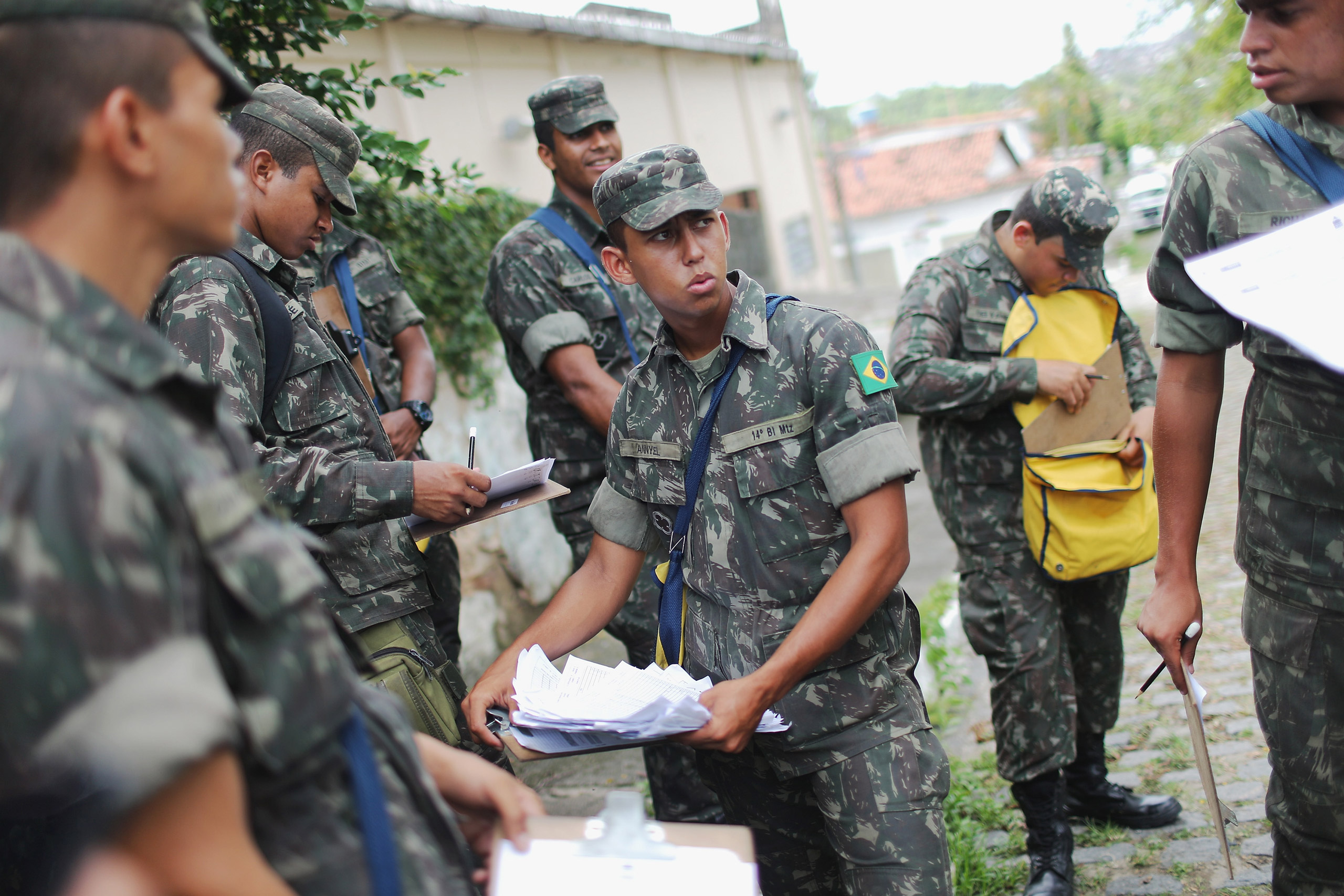 RECIFE, BRAZIL - JANUARY 30: Brazilian Army soldiers gather while canvassing a neighborhood informing the public of preventive methods and searching for potential breeding grounds in an effort to eradicate the mosquitos which transmit the Zika virus on J