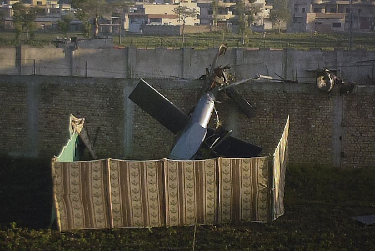 Part of a damaged helicopter is seen lying near the compound where al-Qaeda leader Osama bin Laden was killed in Abbottabad