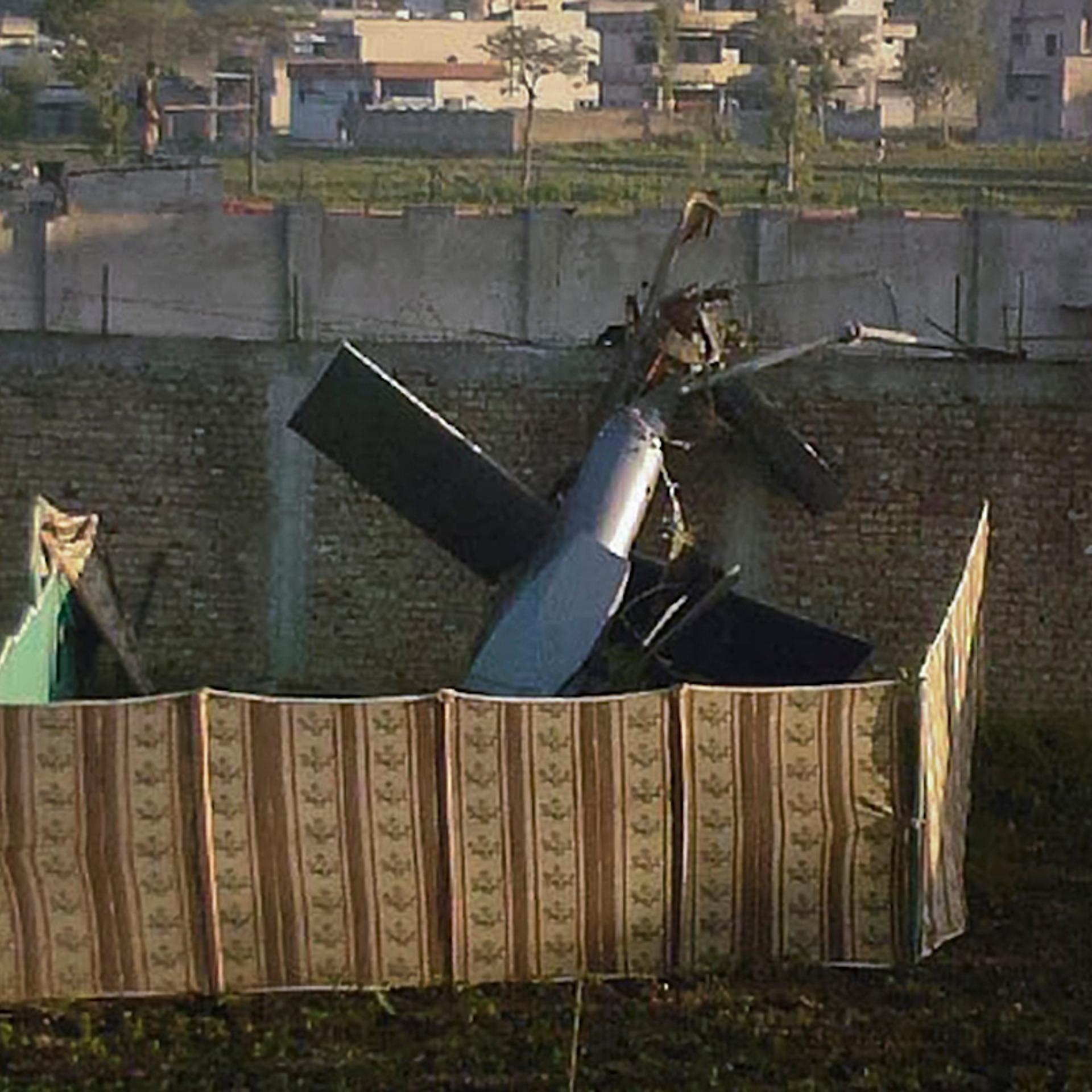 Part of a damaged helicopter is seen lying near the compound where al-Qaeda leader Osama bin Laden was killed in Abbottabad