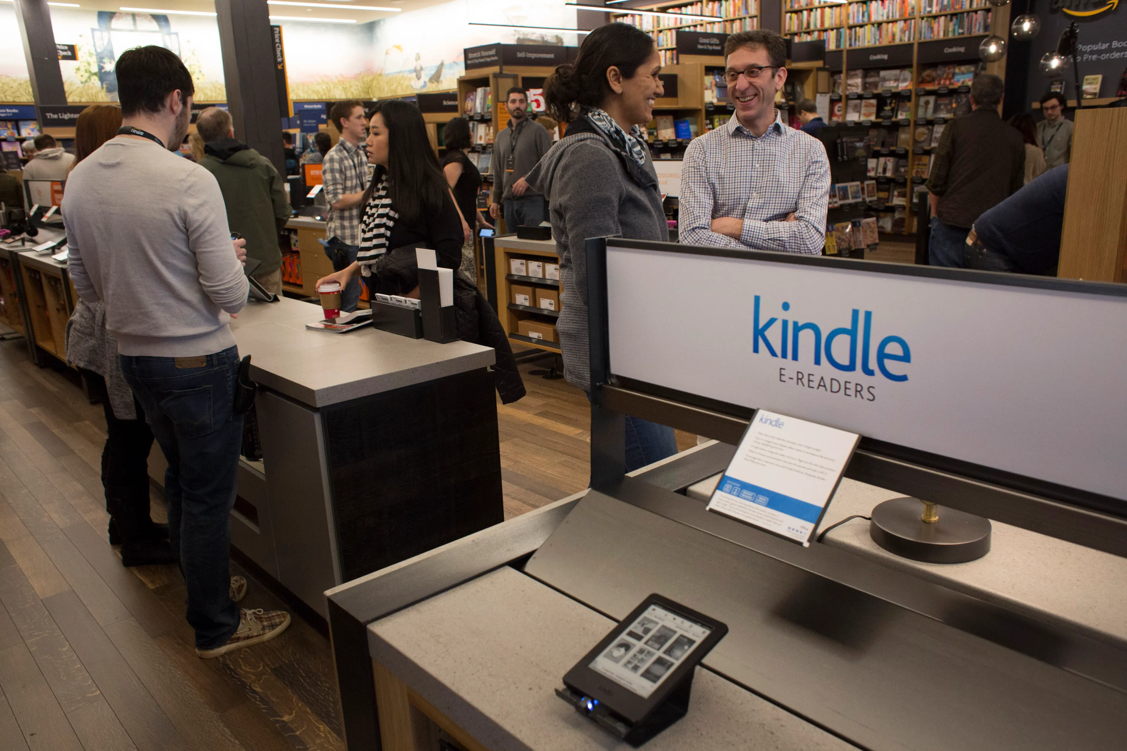 Customers shop at Amazon Books in Seattle, Washington, on Tuesday, Nov. 3, 2015. The online retailer Amazon.com Inc. opened its first brick-and-mortar location in Seattle's upscale University Village mall. Photographer: David Ryder/Bloomberg
