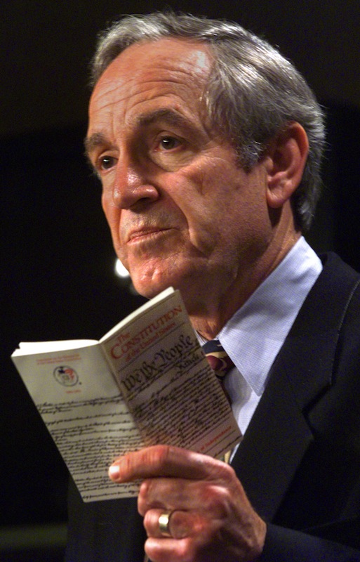 US Senator Tom Harkin(D-IA) waves a pocket copy of