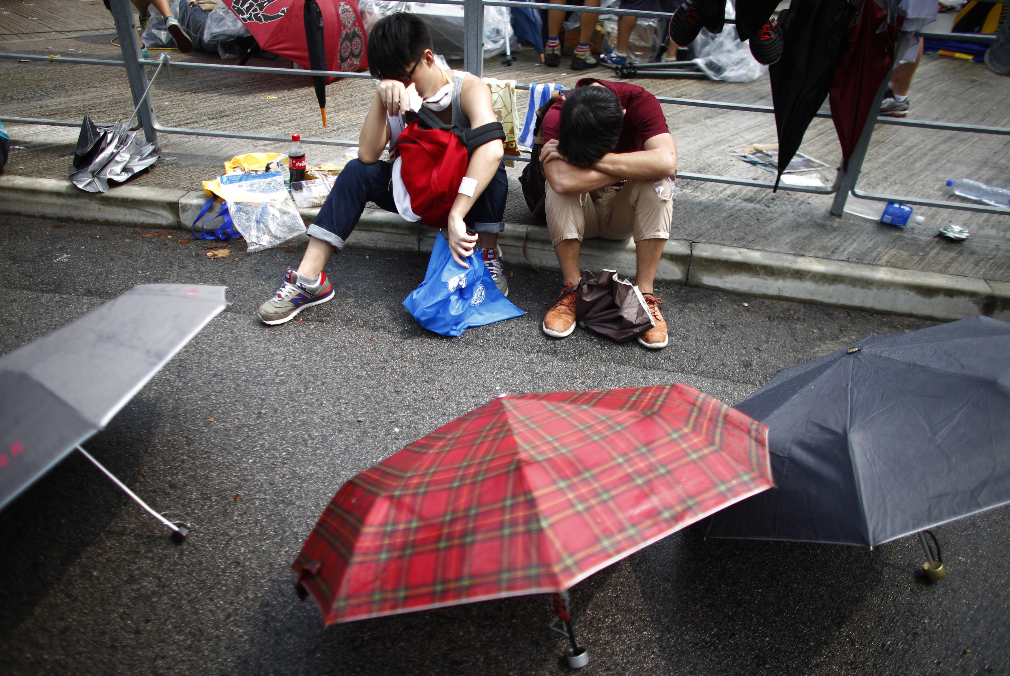 Protesters take a break as the block the entrance of Hong Kong's Chief Executive Leung Chun-ying offices in Hong Kong