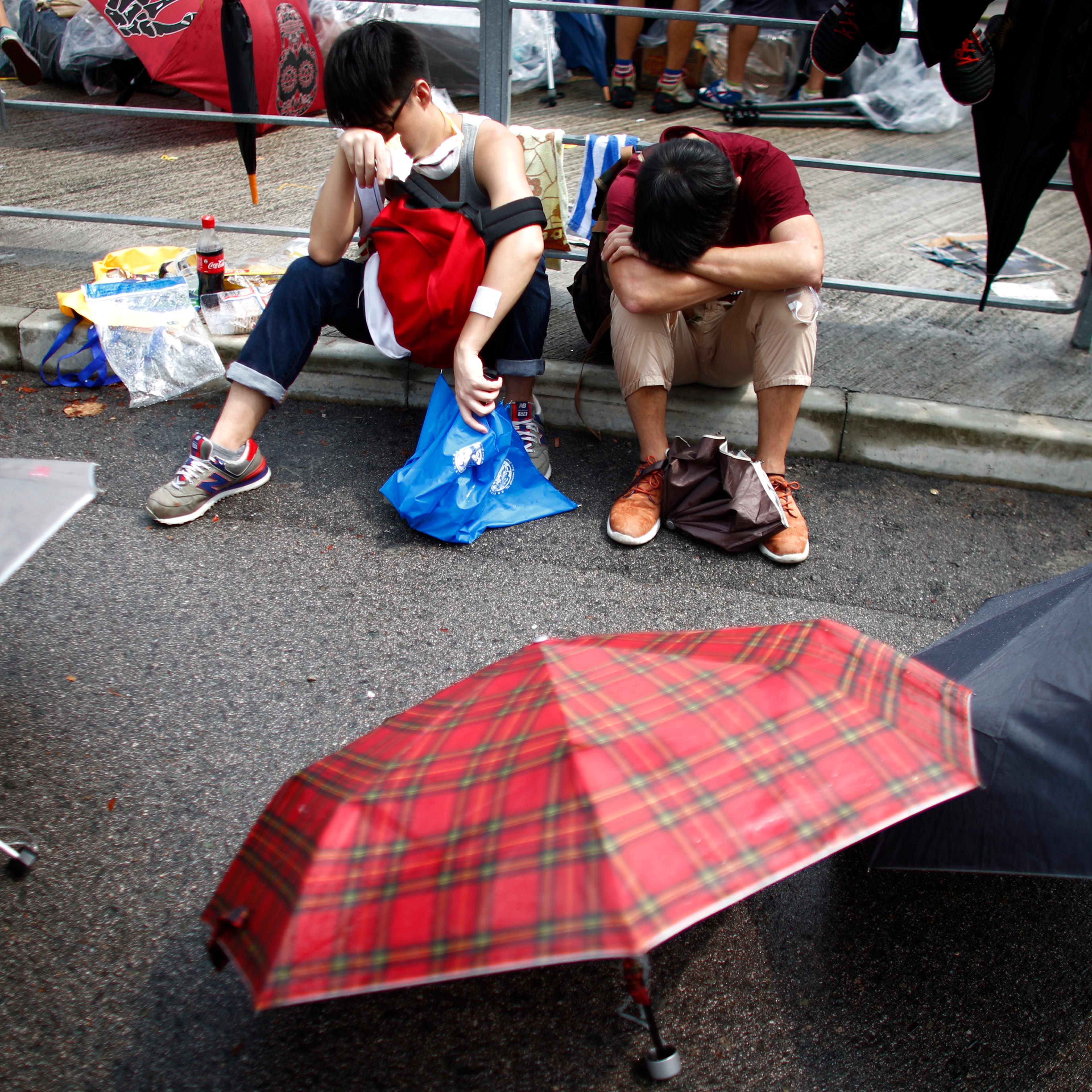 Protesters take a break as the block the entrance of Hong Kong's Chief Executive Leung Chun-ying offices in Hong Kong