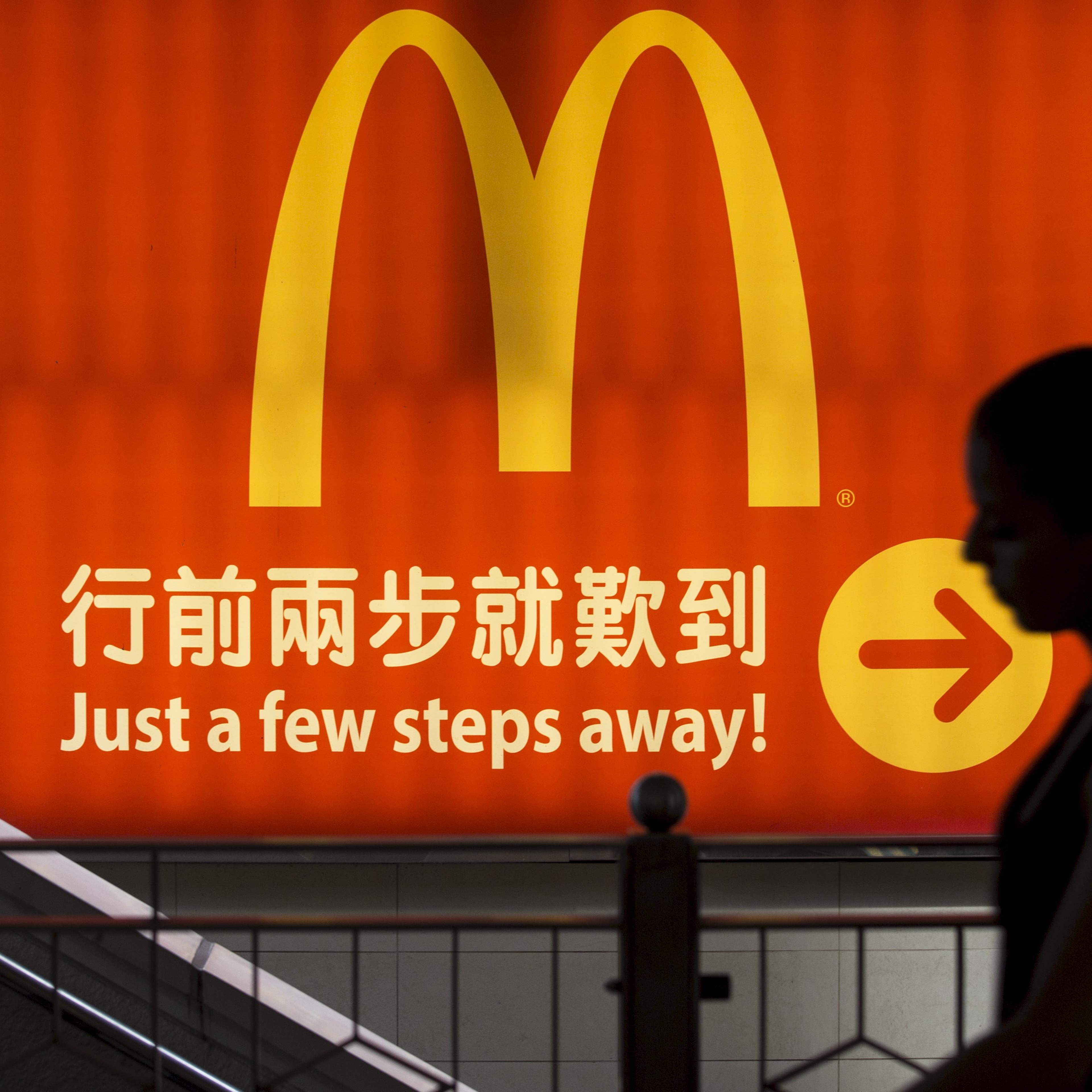File photo of a woman walking past a McDonald's outlet in Hong Kong