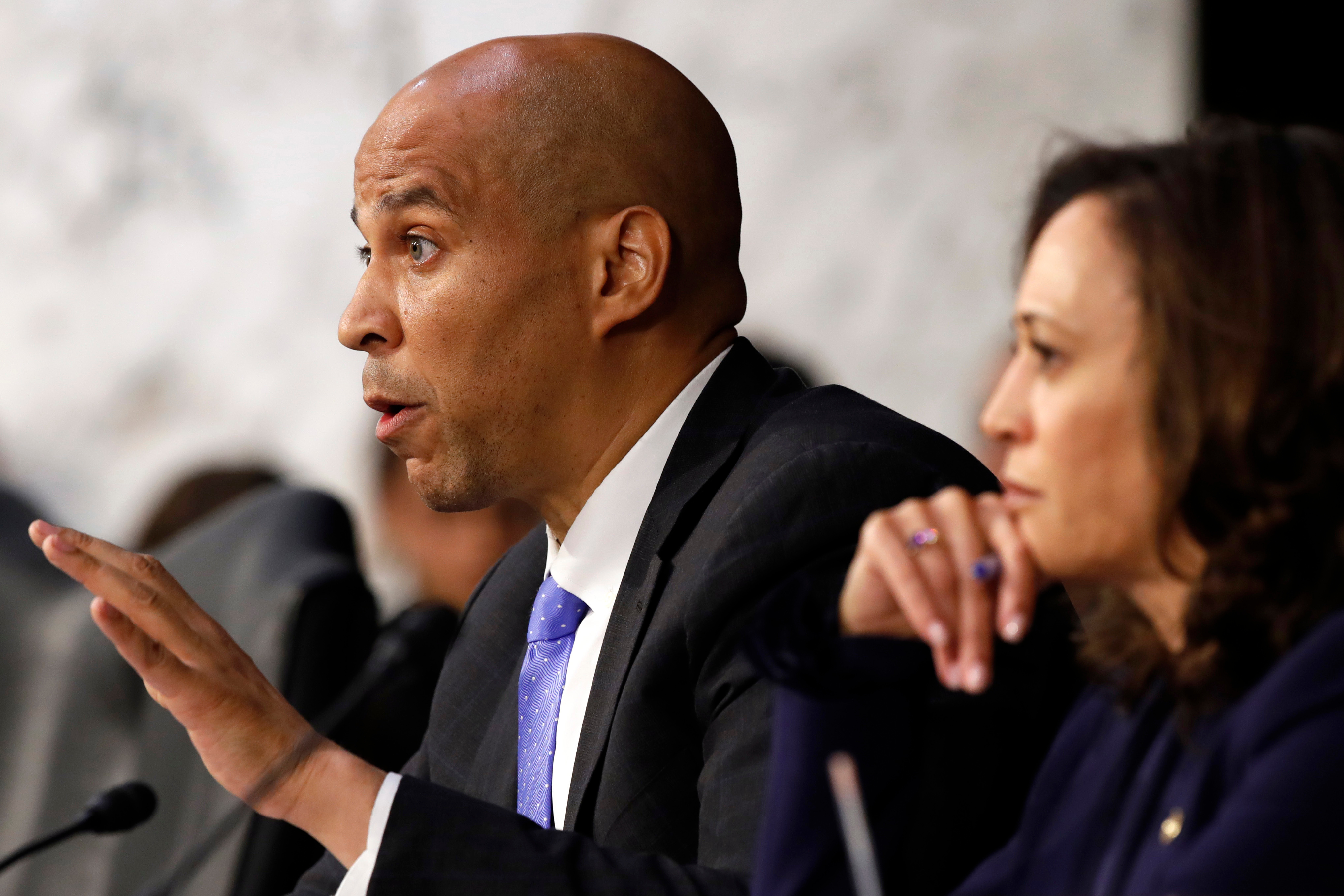 Sen. Cory Booker, D-N.J., left, next to Sen. Kamala Harris