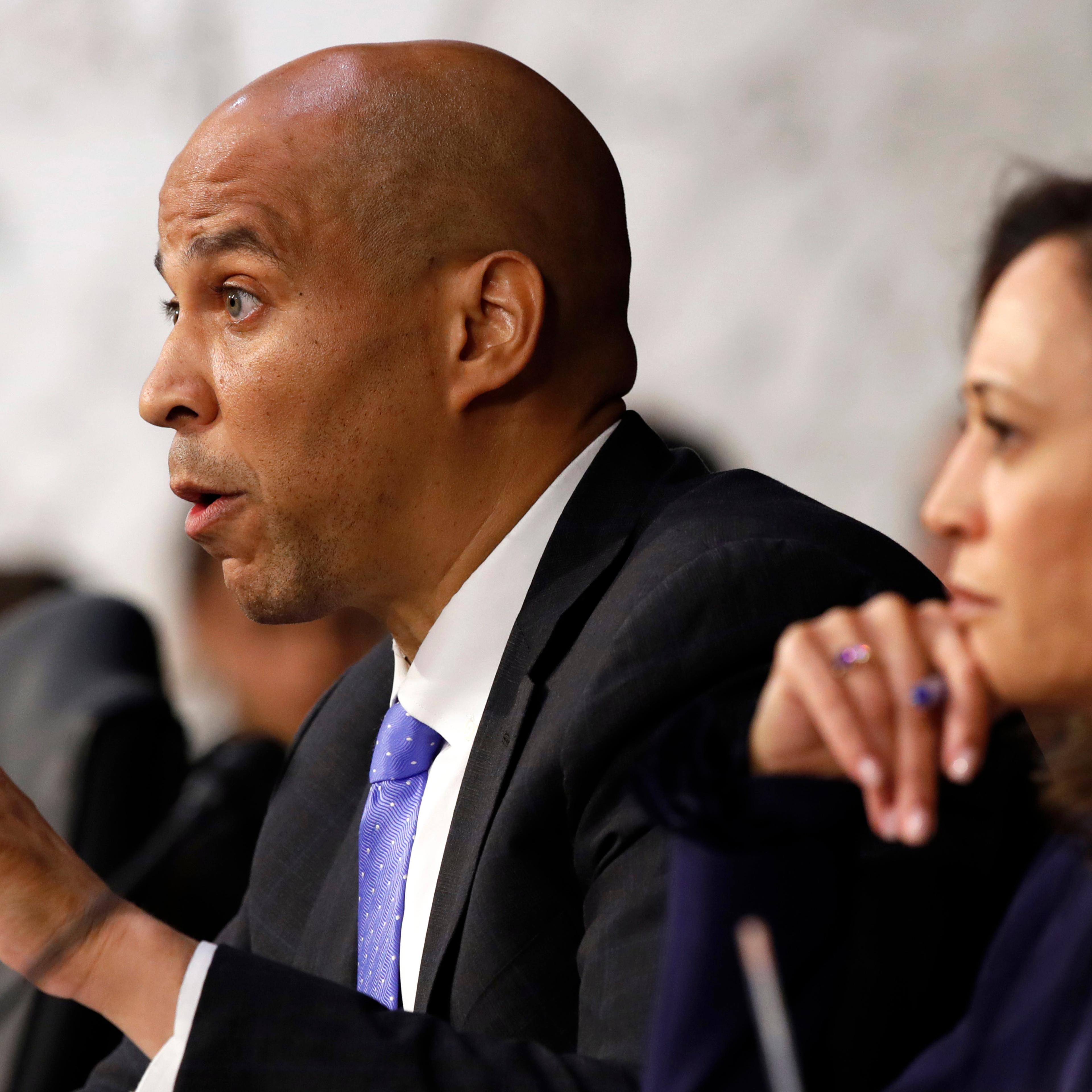 Sen. Cory Booker, D-N.J., left, next to Sen. Kamala Harris
