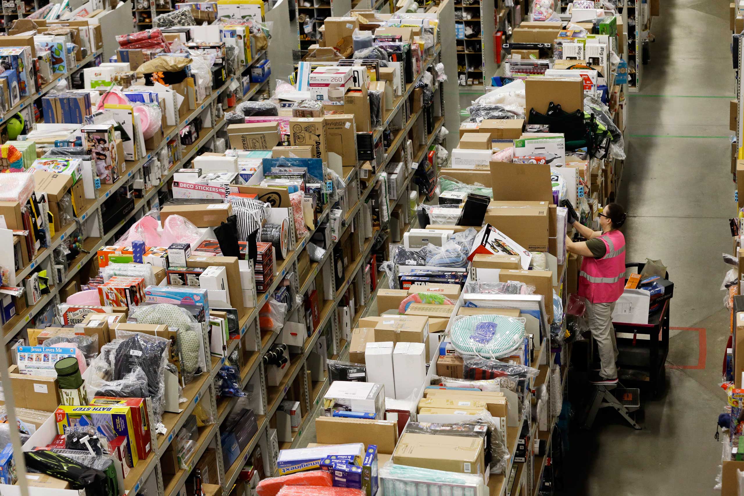 A worker fills orders at the Amazon fulfillment center on Cyber Monday, Dec. 1, 2014, in Lebanon, Tenn.