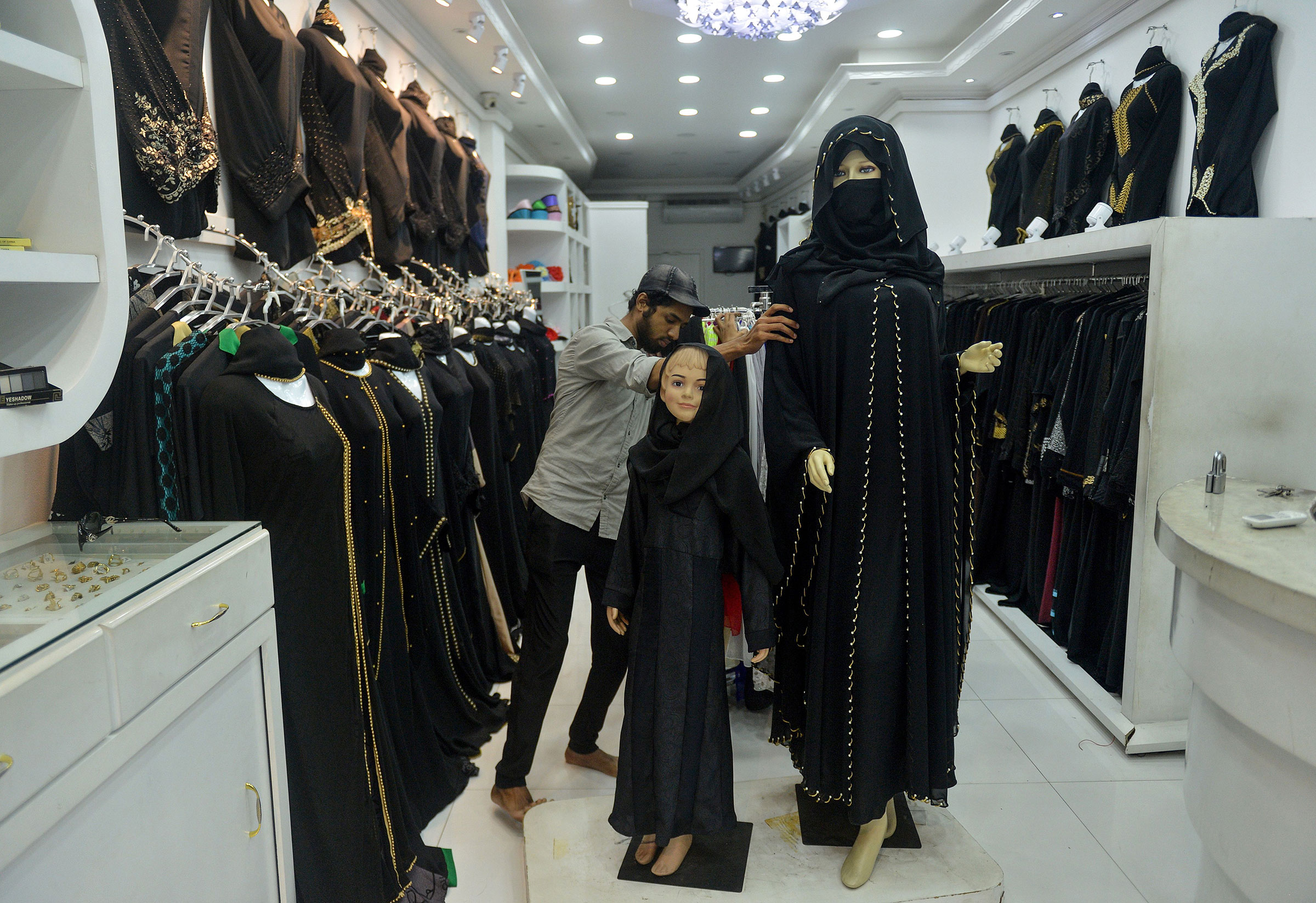 A Sri Lankan vendor shows a full face veil, called a niqab, at a shop selling clothes for Muslim women in Colombo