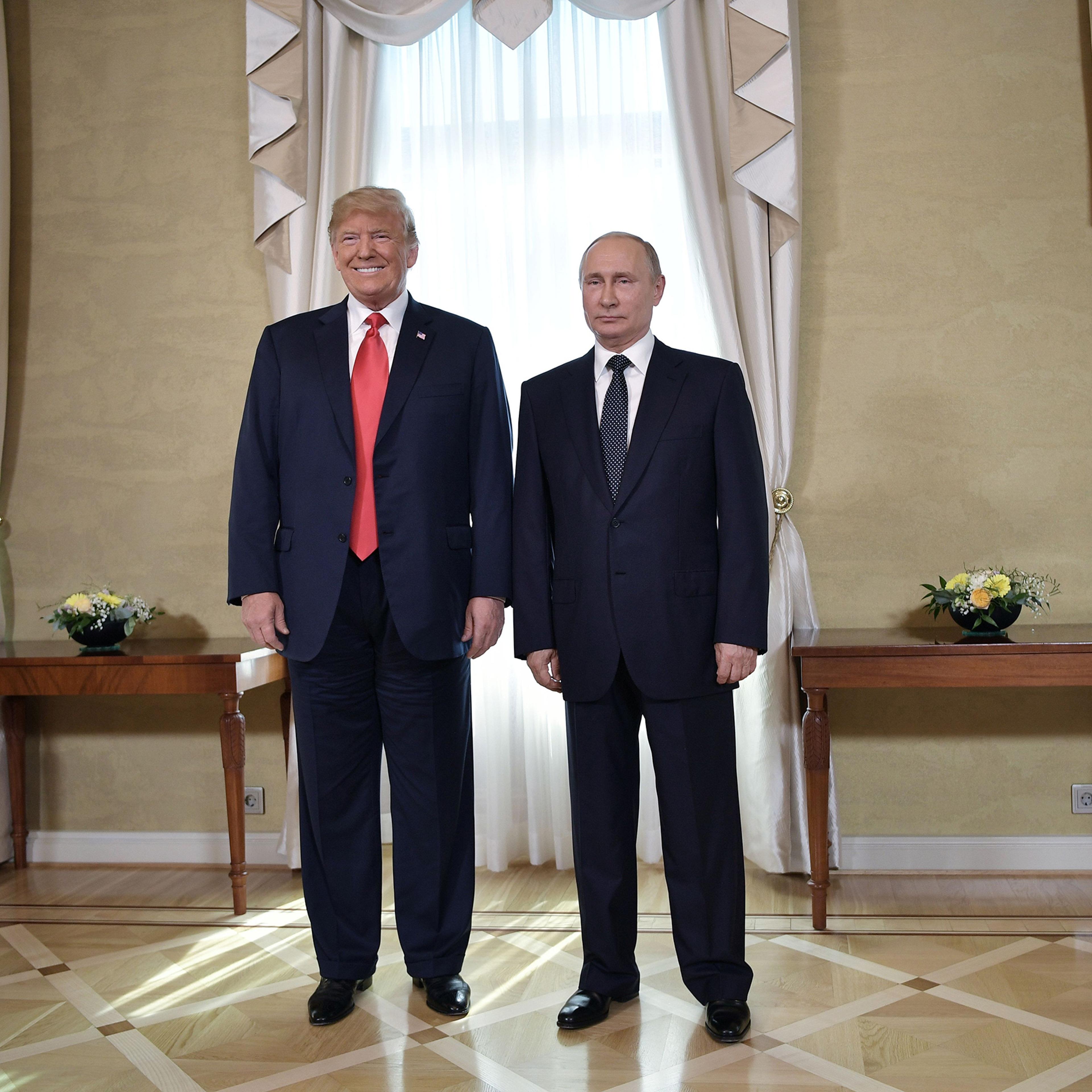 US President Donald Trump and Russia's President Vladimir Putin pose ahead a meeting in Helsinki, on July 16, 2018.