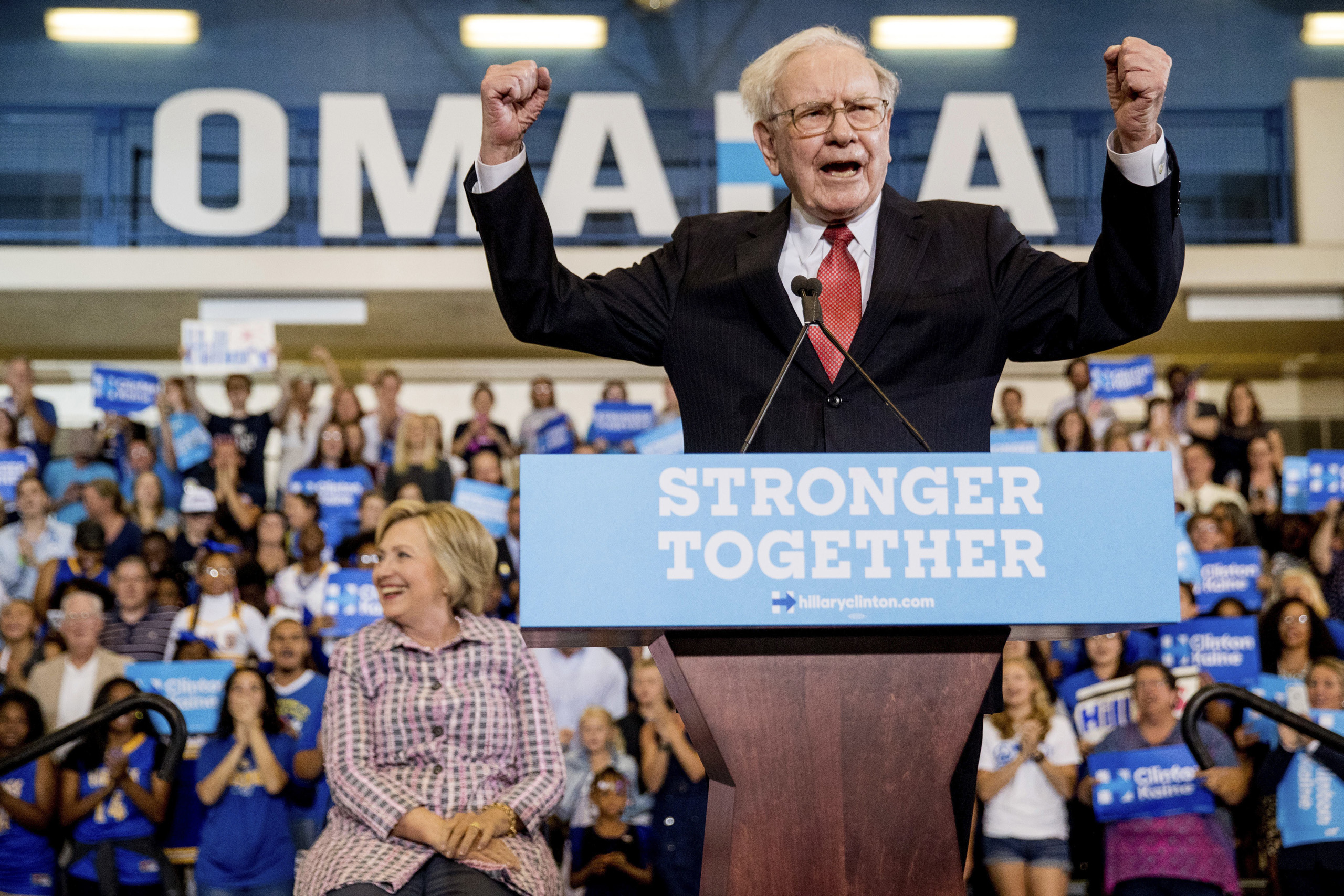 Berkshire Hathaway Chairman and CEO Warren Buffett cheers as he and Democratic presidential candidate Hillary Clinton arrive at a rally at Omaha North High Magnet School in Omaha, Neb. on Aug. 1, 2016.