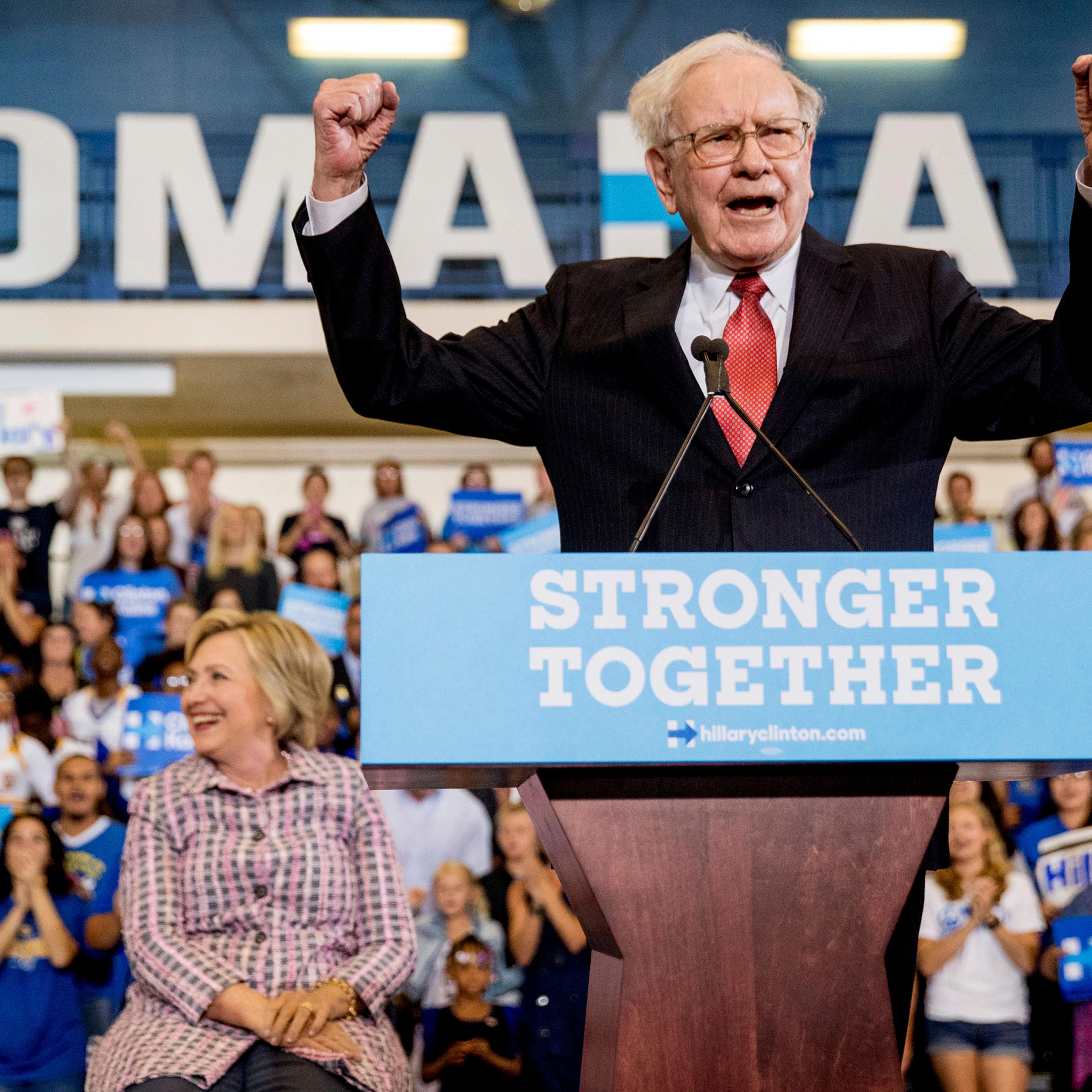 Berkshire Hathaway Chairman and CEO Warren Buffett cheers as he and Democratic presidential candidate Hillary Clinton arrive at a rally at Omaha North High Magnet School in Omaha, Neb. on Aug. 1, 2016.