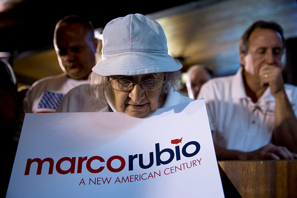 Supporters pause during a prayer before Senator Marco Rubio, a Republican from Florida and 2016 Republican presidential candidate, not pictured, speaks during a rally at Town Hall restaurant ahead of the Fox News Republican Presidential Primary Debate in