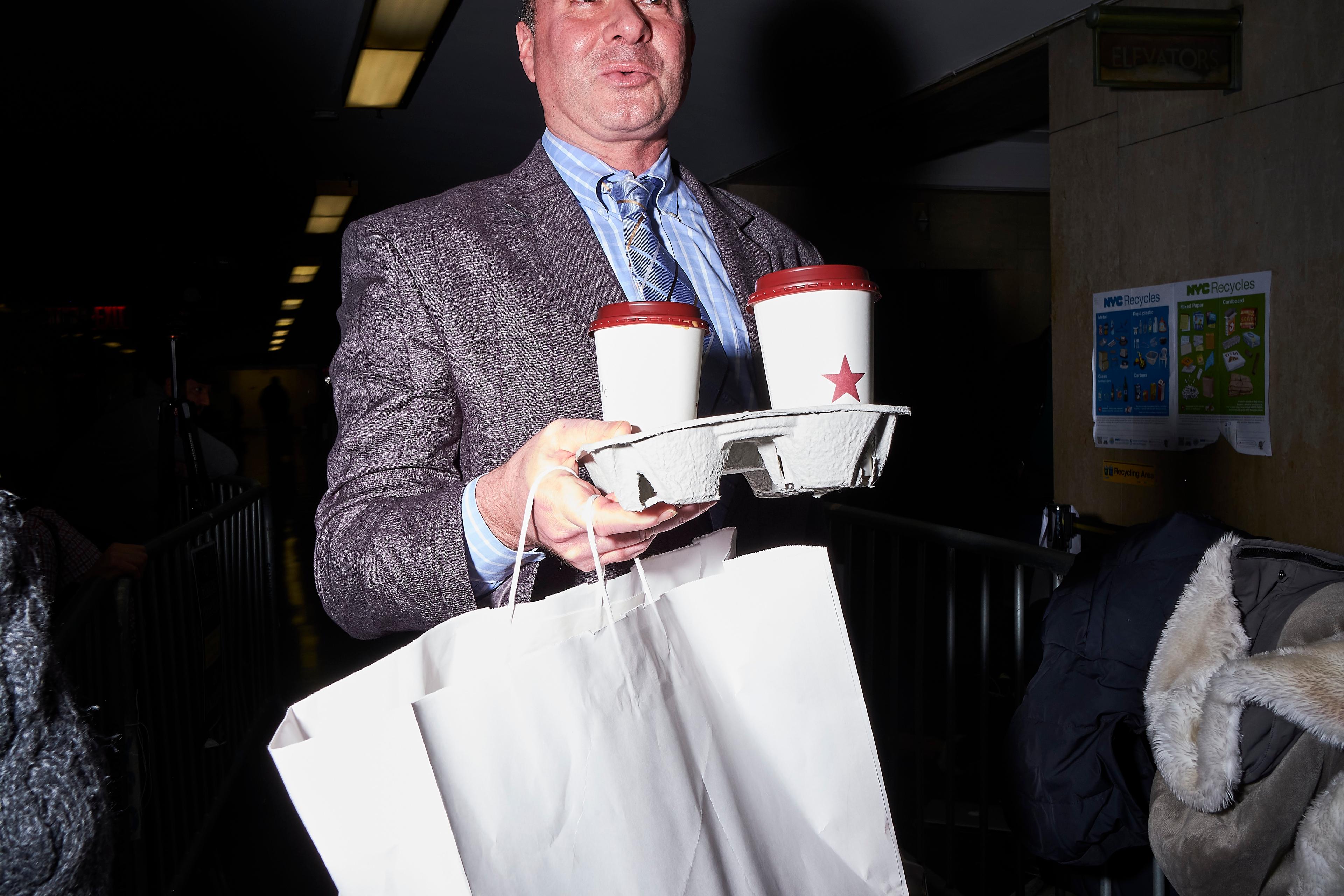 A member of Harvey Weinstein's legal team delivers lunch to Weinstein in the courtroom on Jan. 22, 2020.