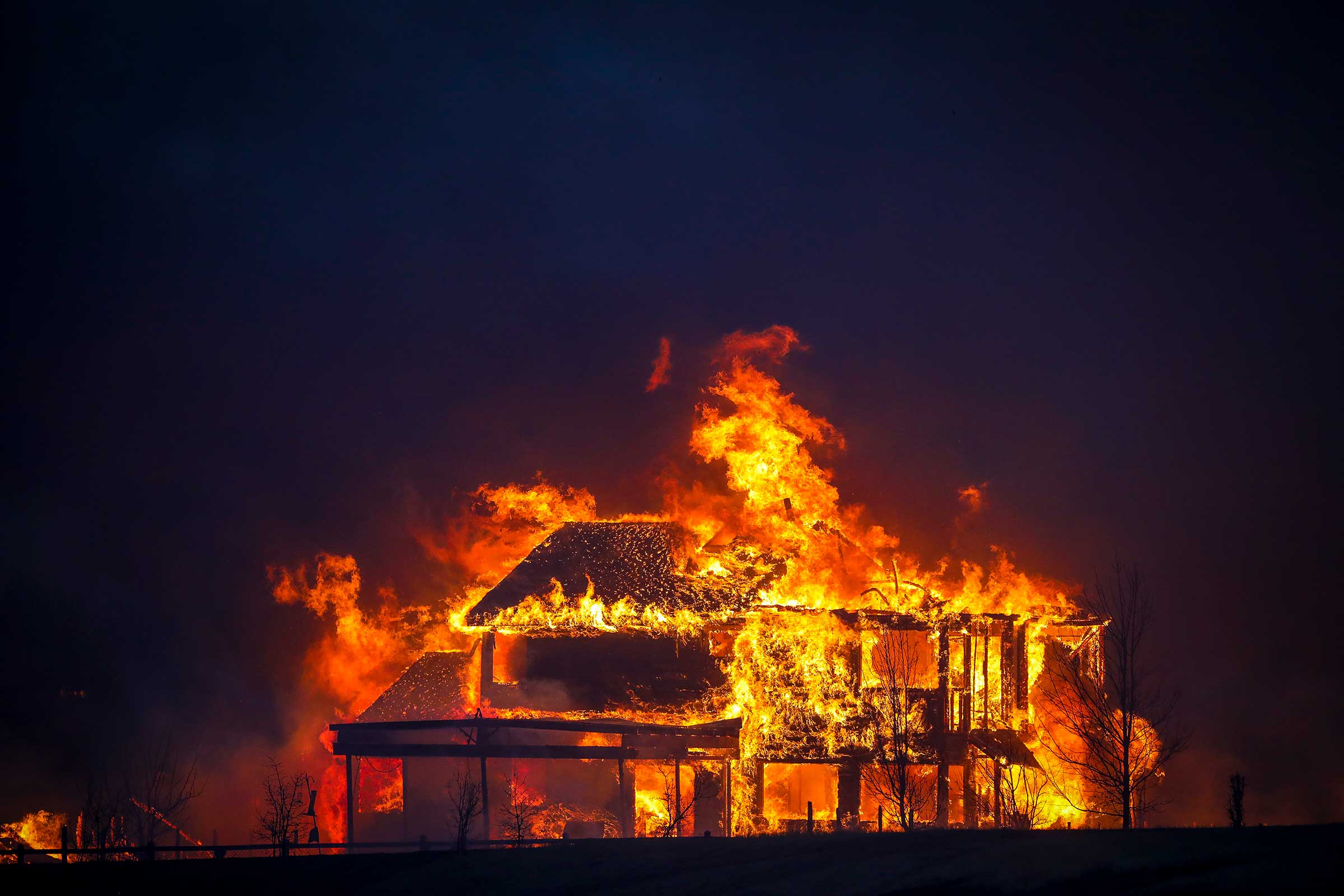 A home burns after a fast moving wildfire swept through the area in the Centennial Heights neighborhood of Louisville, Colorado on Dec. 30, 2021. 