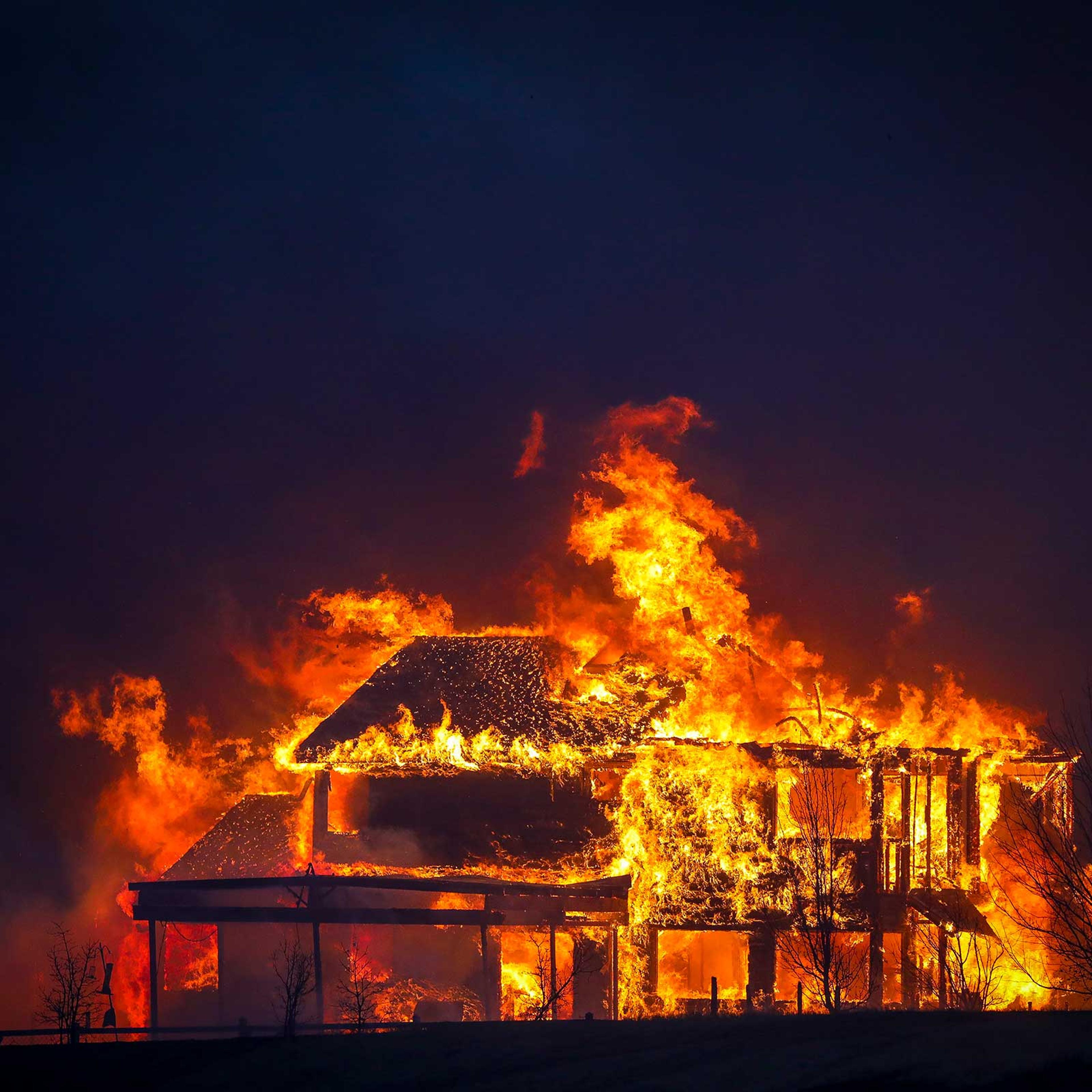 A home burns after a fast moving wildfire swept through the area in the Centennial Heights neighborhood of Louisville, Colorado on Dec. 30, 2021.