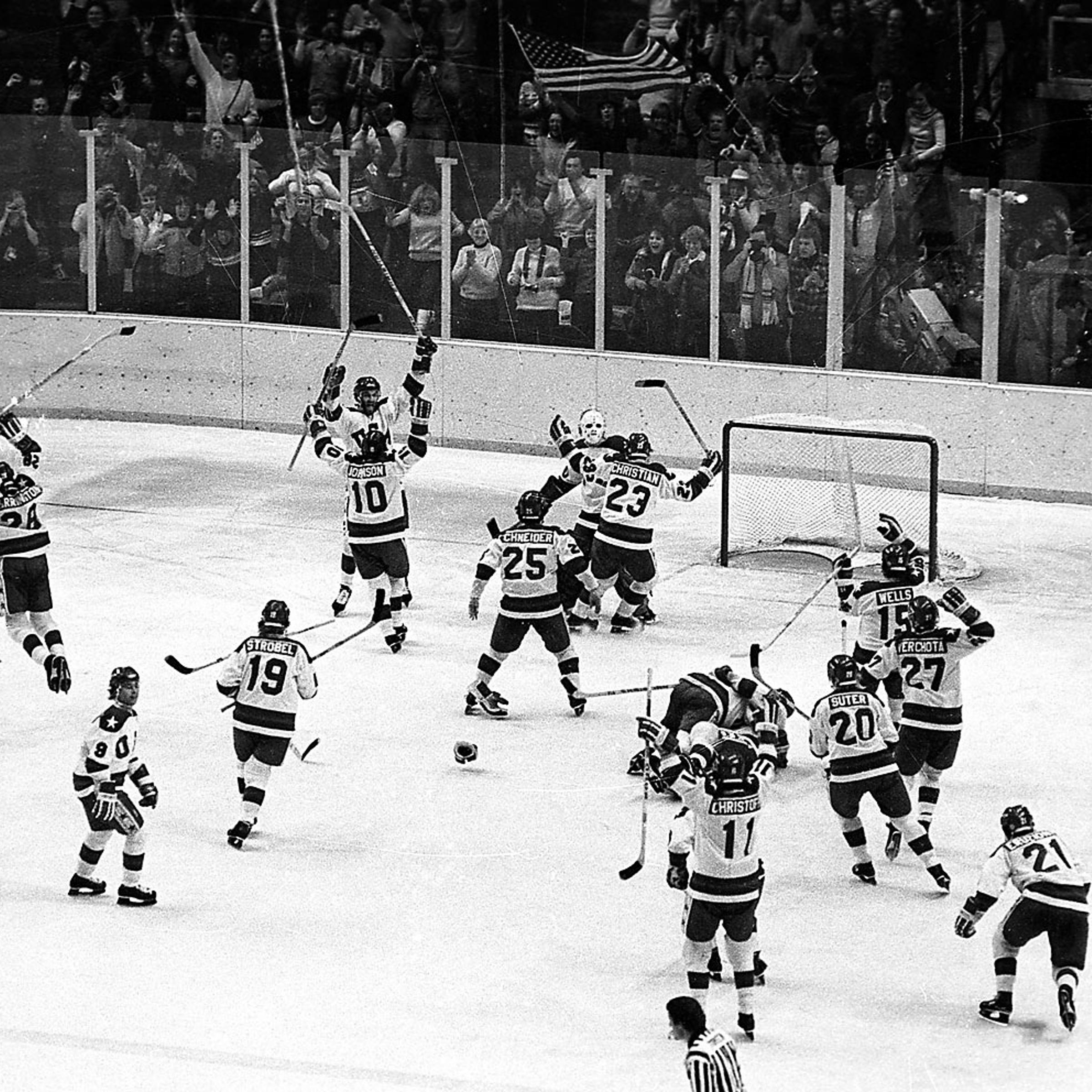 The U.S ice hockey team rushes toward goalie Jim Craig after their upset win over the Soviet Union in the semi-final round of the XIII Winter Olympic Games in Lake Placid, N.Y., Feb. 22, 1980.