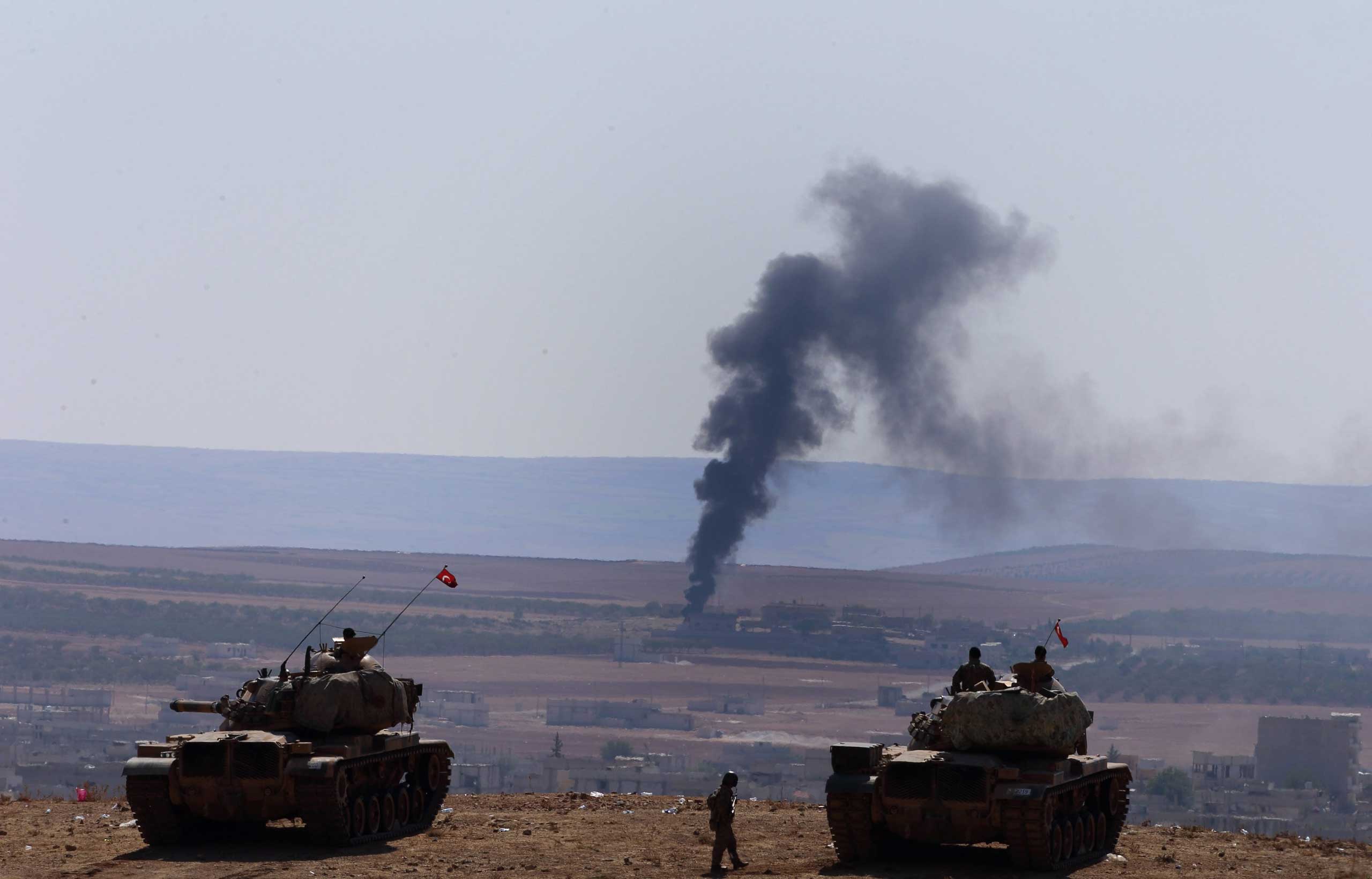 A picture taken from Turkey shows smoke rising after an airstrike by an alleged alliance war plane on the ISIS targets in the west of Kobane, Syria, where Kurdish fighters are trying to defend the city, near Suruc district, Sanliurfa, Turkey, Oct. 8, 201