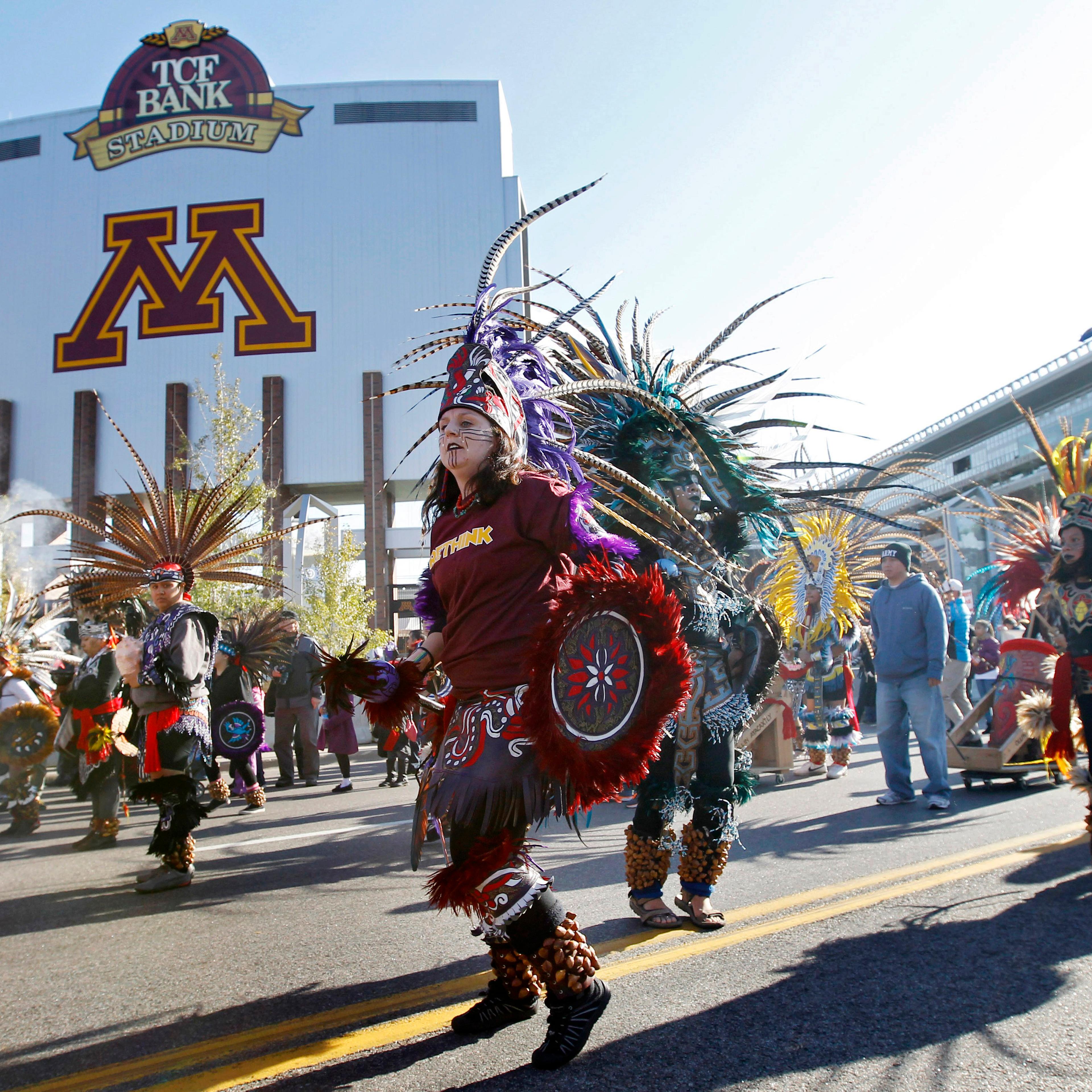 Protestors march outside TCF Bank Stadium before an NFL football game between the Minnesota Vikings and the Washington Redskins on Nov. 2, 2014, in Minneapolis.