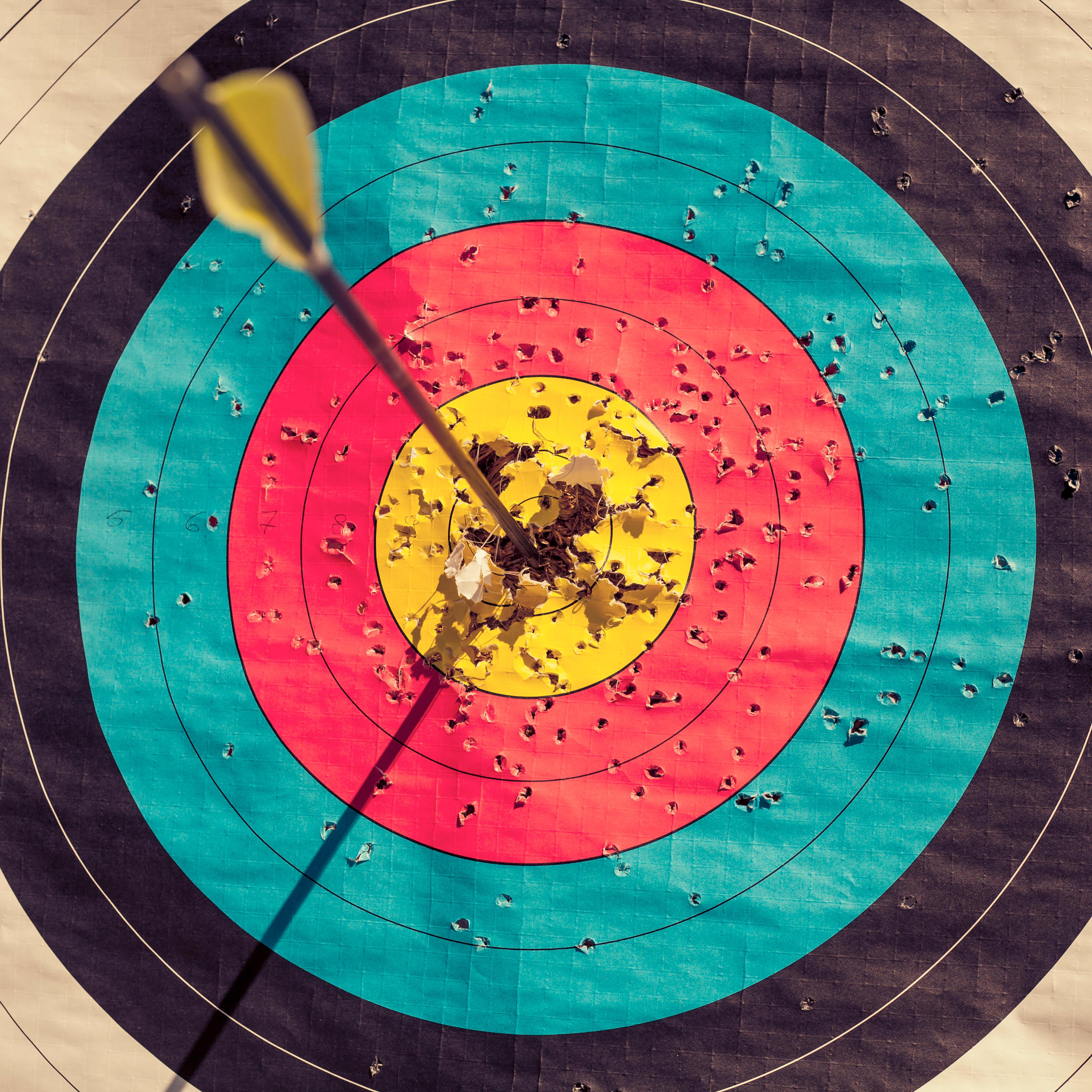 Archery target with arrow in the centre