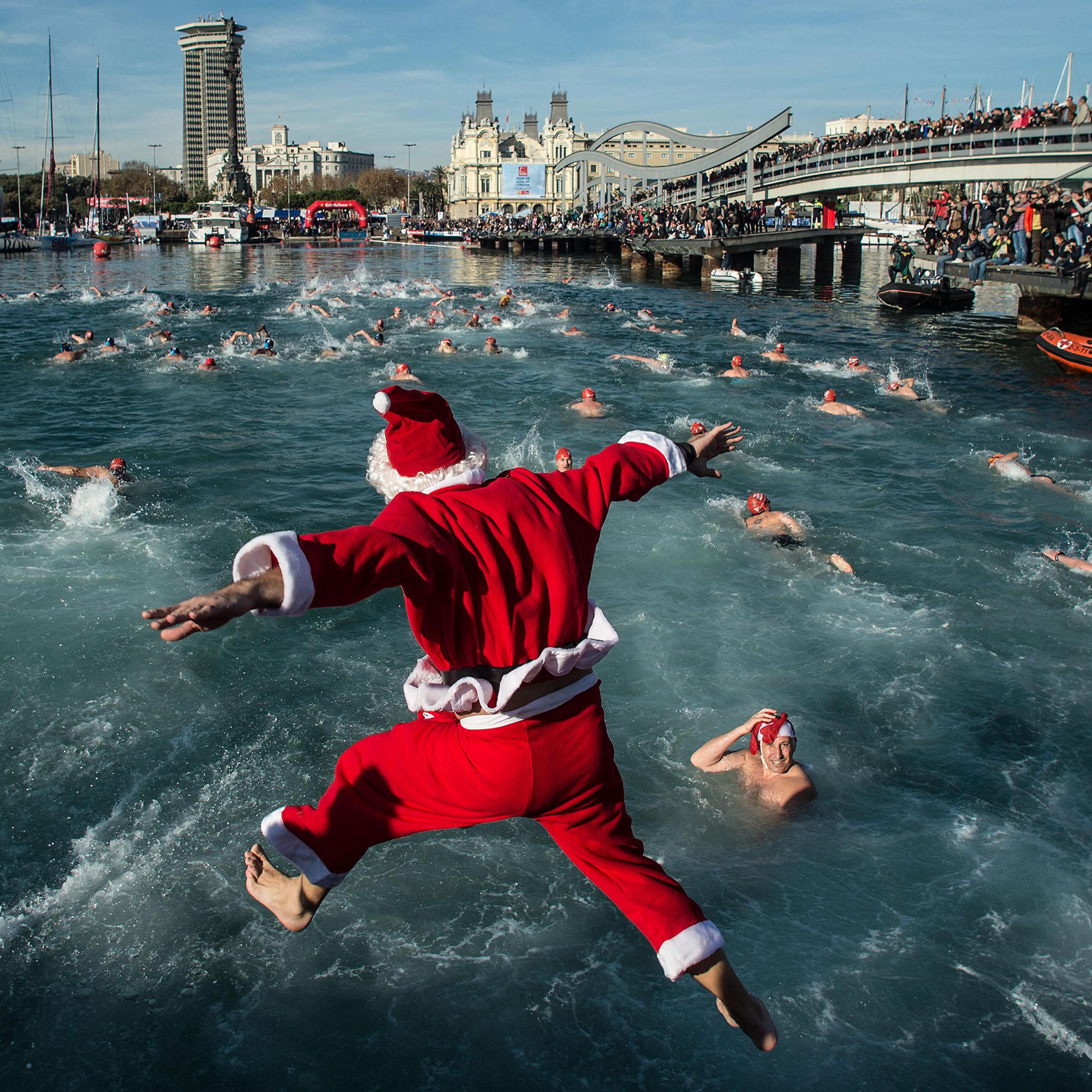 A competitor in Christmas fancy dress jumps into the sea during the 105th Barcelona Traditional Christmas Swimming Cup at the Old Harbour of Barcelona on Dec. 25, 2014 in Barcelona, Spain. The Copa Nadal is organised by the Barcelona Swimming Club and in
