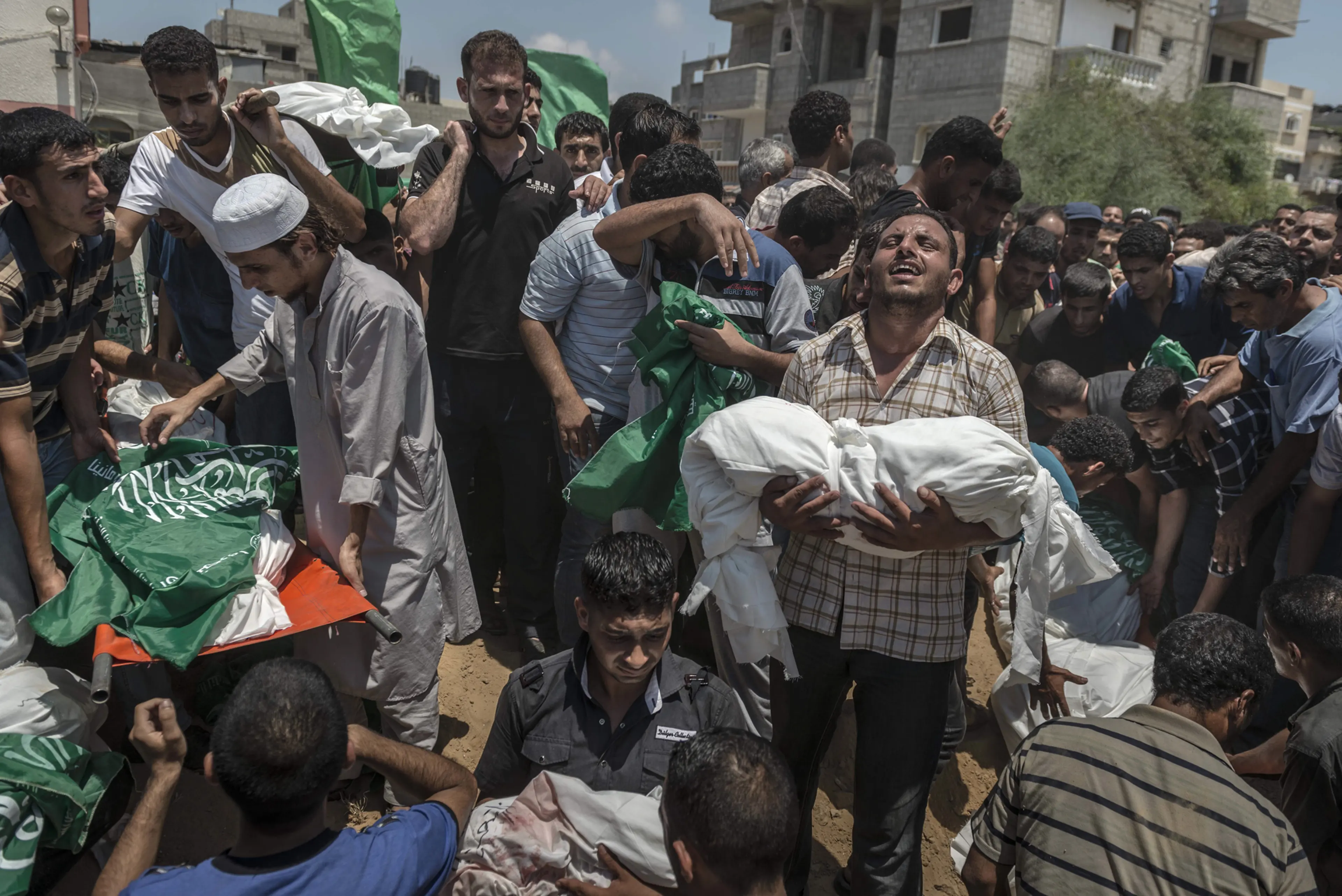 Palestinian men bury the bodies of a family who was killed after airstrike in Khan Younis, in the Gaza Strip.