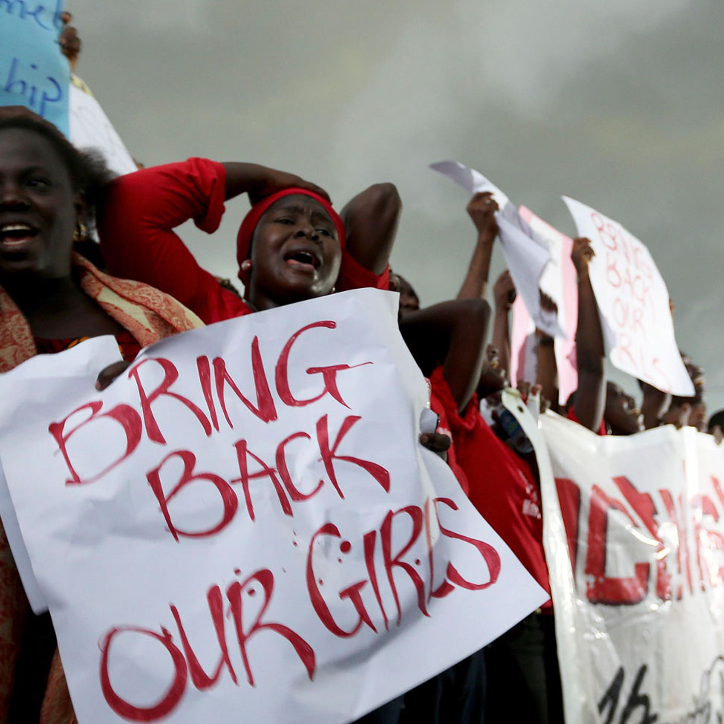 Women react during a protest demanding security forces to search harder for 200 abducted schoolgirls, outside Nigeria's parliament in Abuja