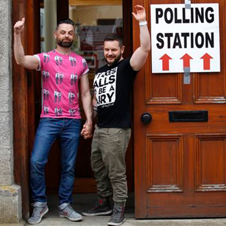 Partners Adrian, left and Shane, arrive to cast their vote at a polling station in Drogheda, Ireland