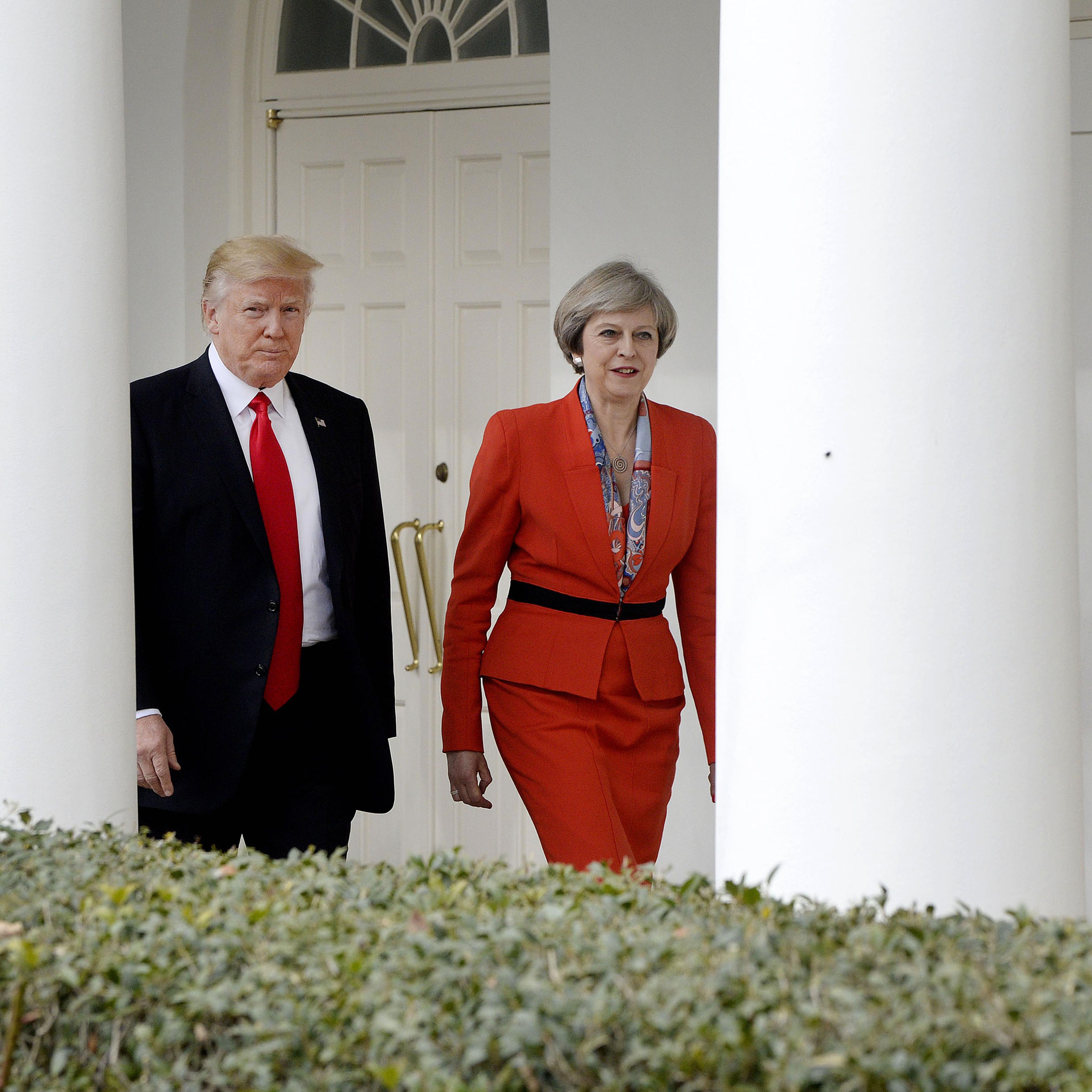 President Donald Trump, left, walks with Theresa May, U.K. prime minister, outside of the White House in Washington, on Jan. 27, 2017.