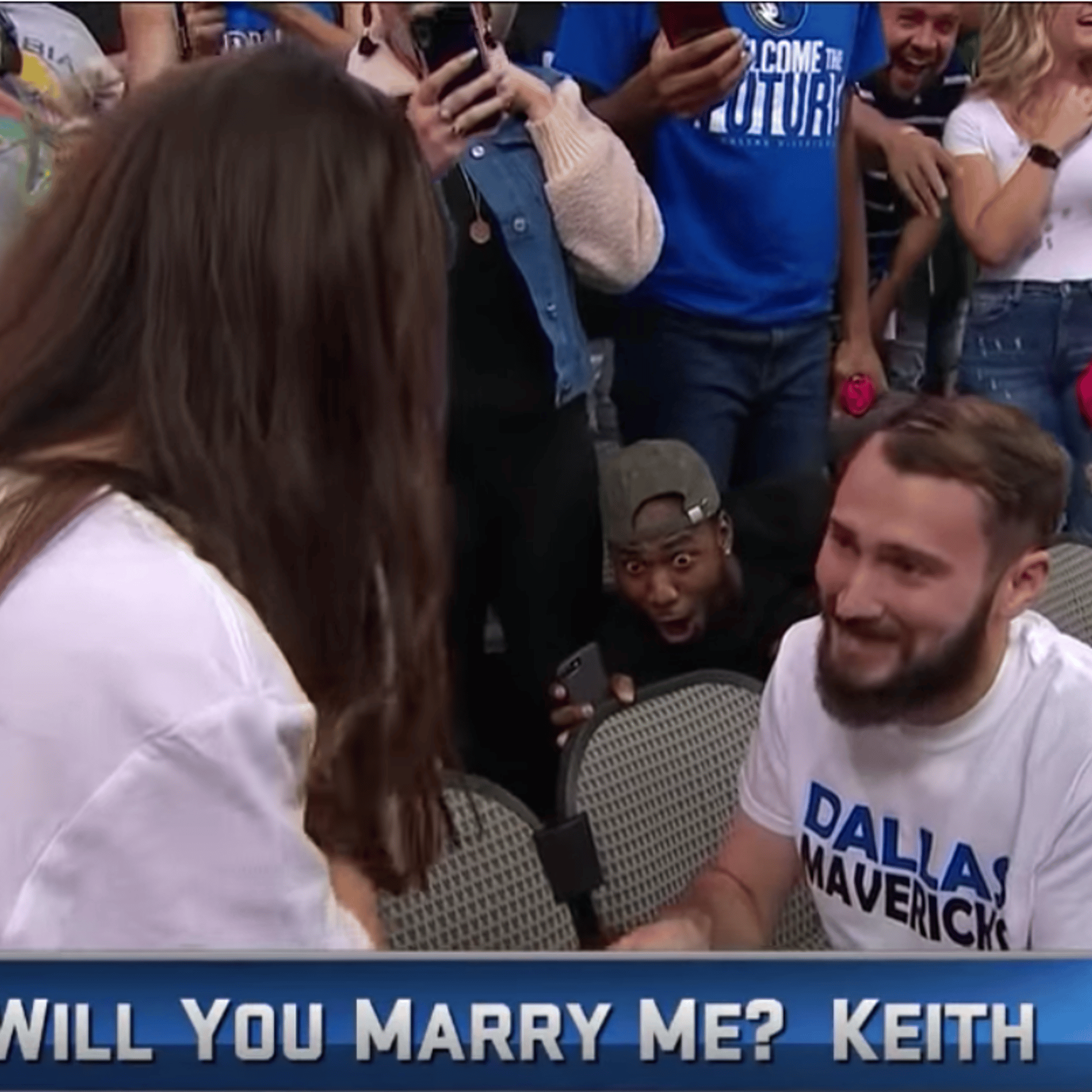 This photo taken from video shows Jonathan Miller's excited reaction to the wedding proposal at the Dallas Mavericks game on Sunday, Oct. 28, 2018.