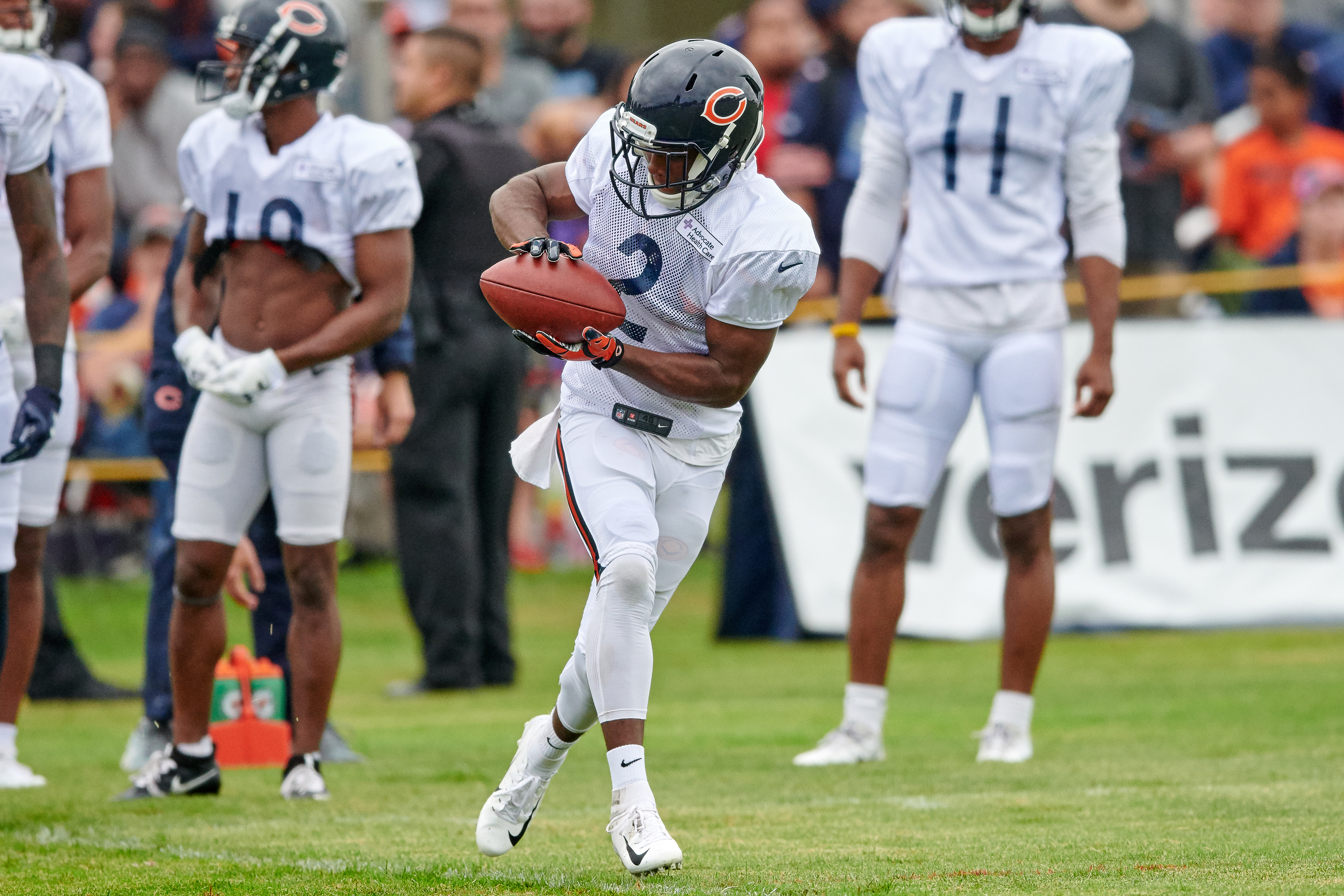 A football player catches the ball during practice