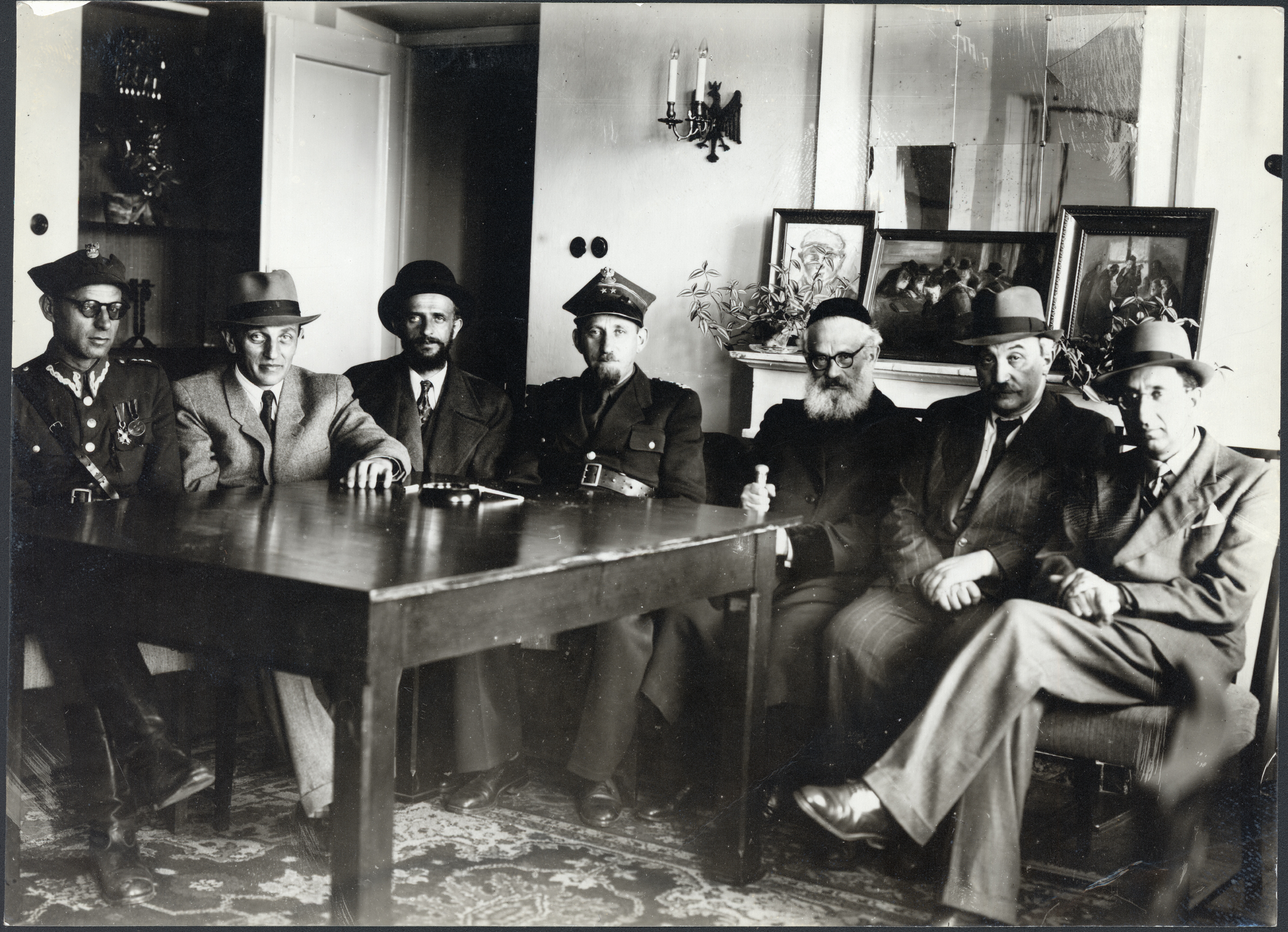 Visit of the Chief Rabbi of Jerusalem to the JDC offices in Warsaw; left to right in photo: Captain Beker, Mizrachi; Mr. Zylberberg, secretary-general of the Central Religious Congregation; Rabbi Efrusi of Warsaw; Colonel Kahane, chief rabbi of the Polish Army; Rabbi Isaac Herzog, chief rabbi of Jerusalem; Mr. Atbor, president of the Jewish Religious Congregation in Lodz; and Joseph Gitler-Barski; general secretary of the JDC office in Warsaw; c. 1946.