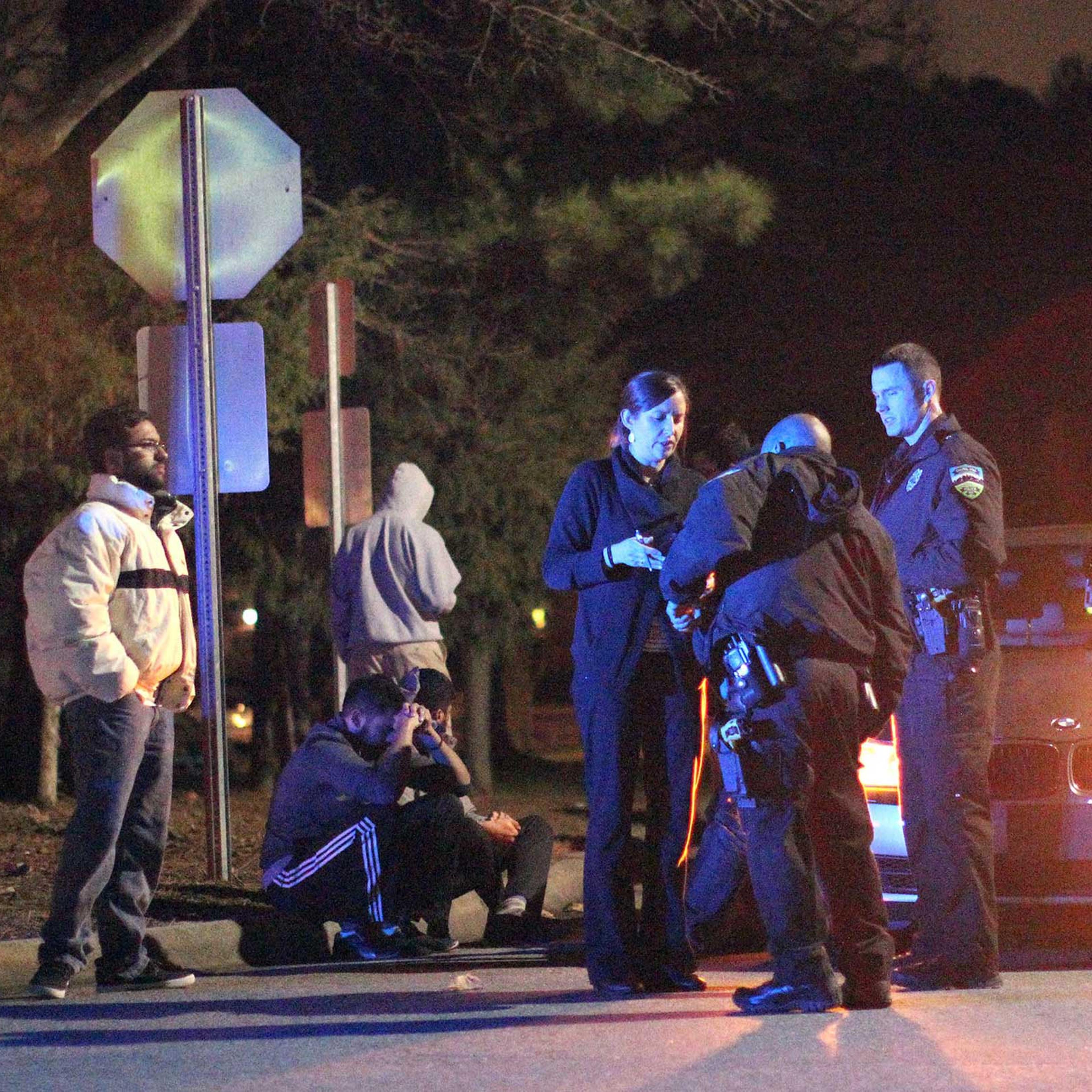 Chapel Hill police officers investigate the scene of three murders near Summerwalk Circle in Chapel Hill, N.C., Feb. 10, 2015.