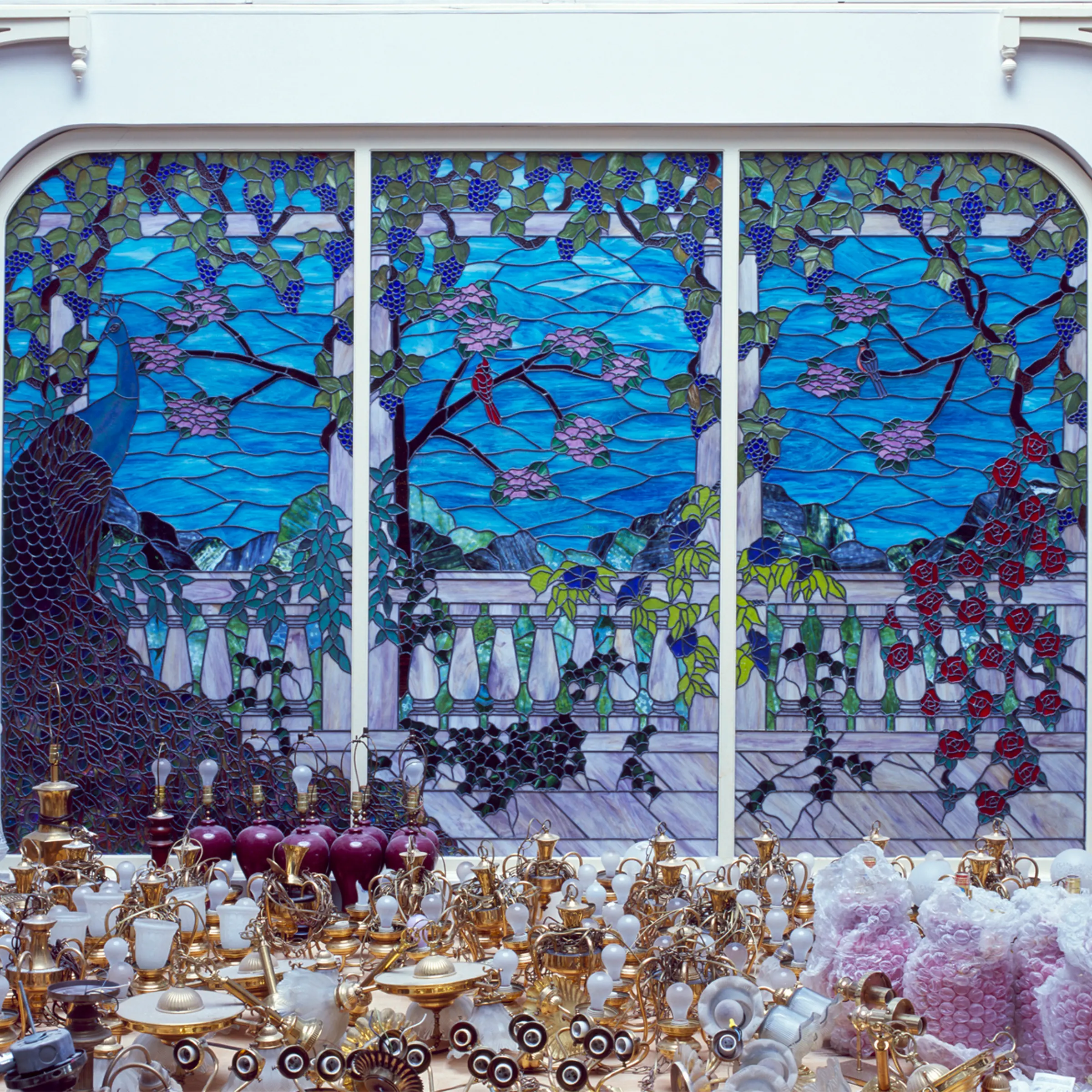Light fixtures that were part of Heritage USA are piled up near a stained-glass window during renovations to the building.