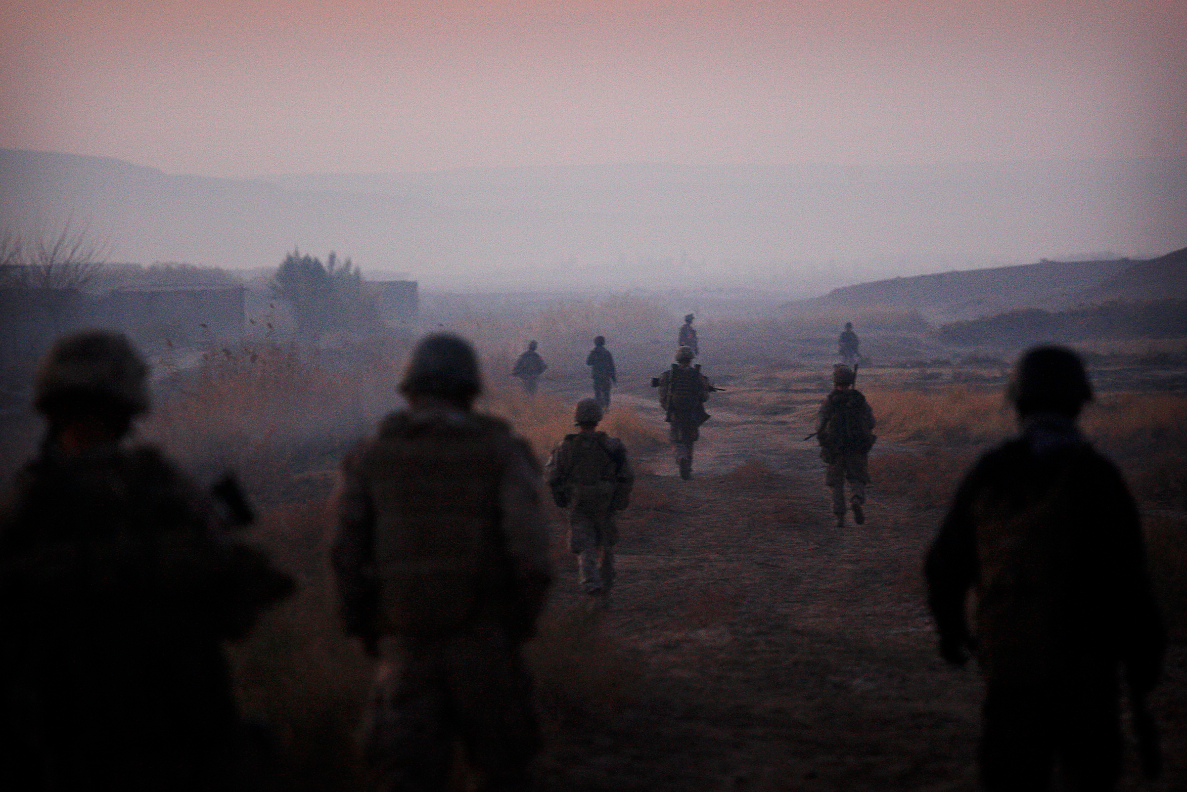 U.S. Marines from the 2nd Battalion, 2nd Marines and Afghan National Army soldiers walk in formation during an operation in the Garmsir district of the volatile Helmand province, in southern Afghanistan, on Dec. 23, 2009.