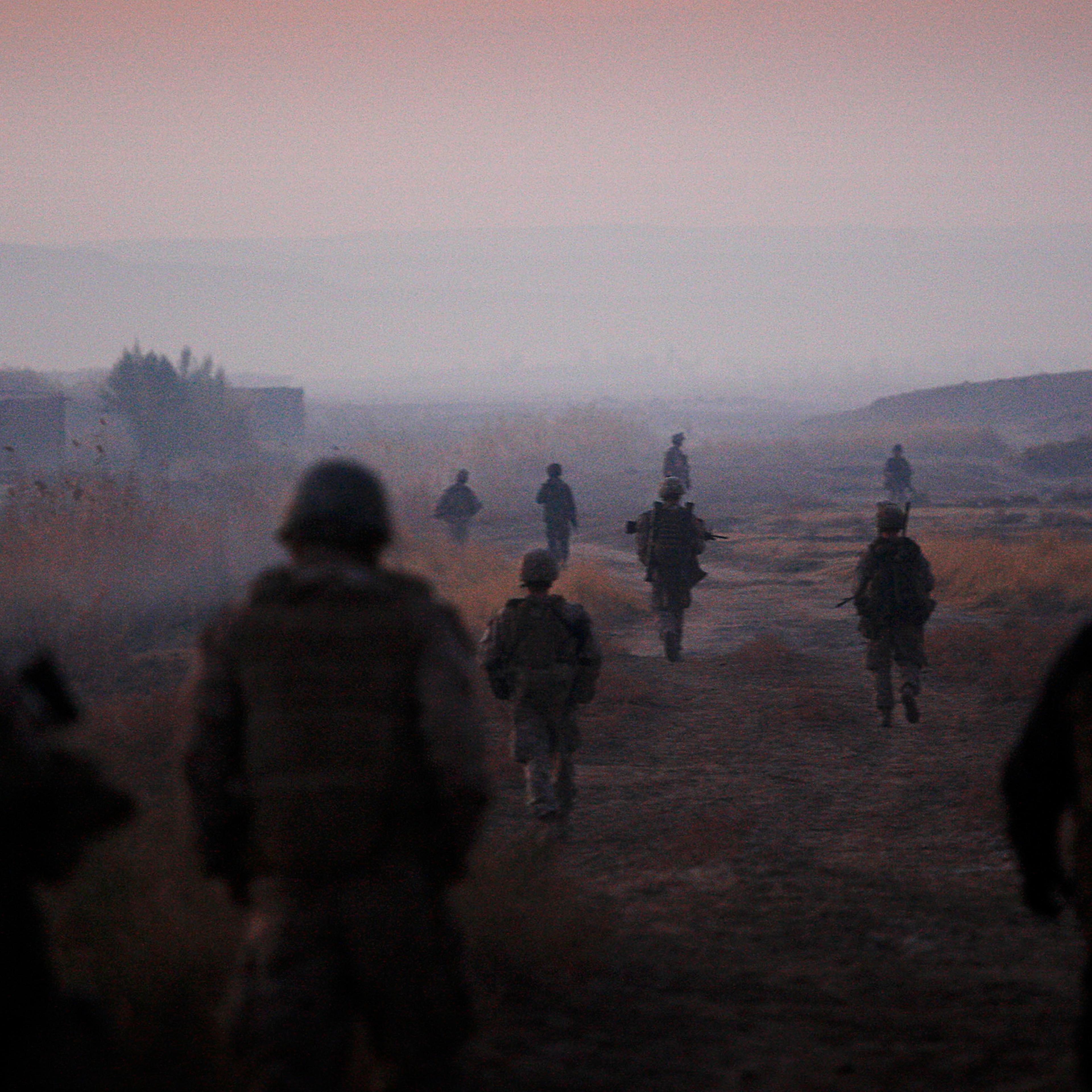 U.S. Marines from the 2nd Battalion, 2nd Marines and Afghan National Army soldiers walk in formation during an operation in the Garmsir district of the volatile Helmand province, in southern Afghanistan, on Dec. 23, 2009.