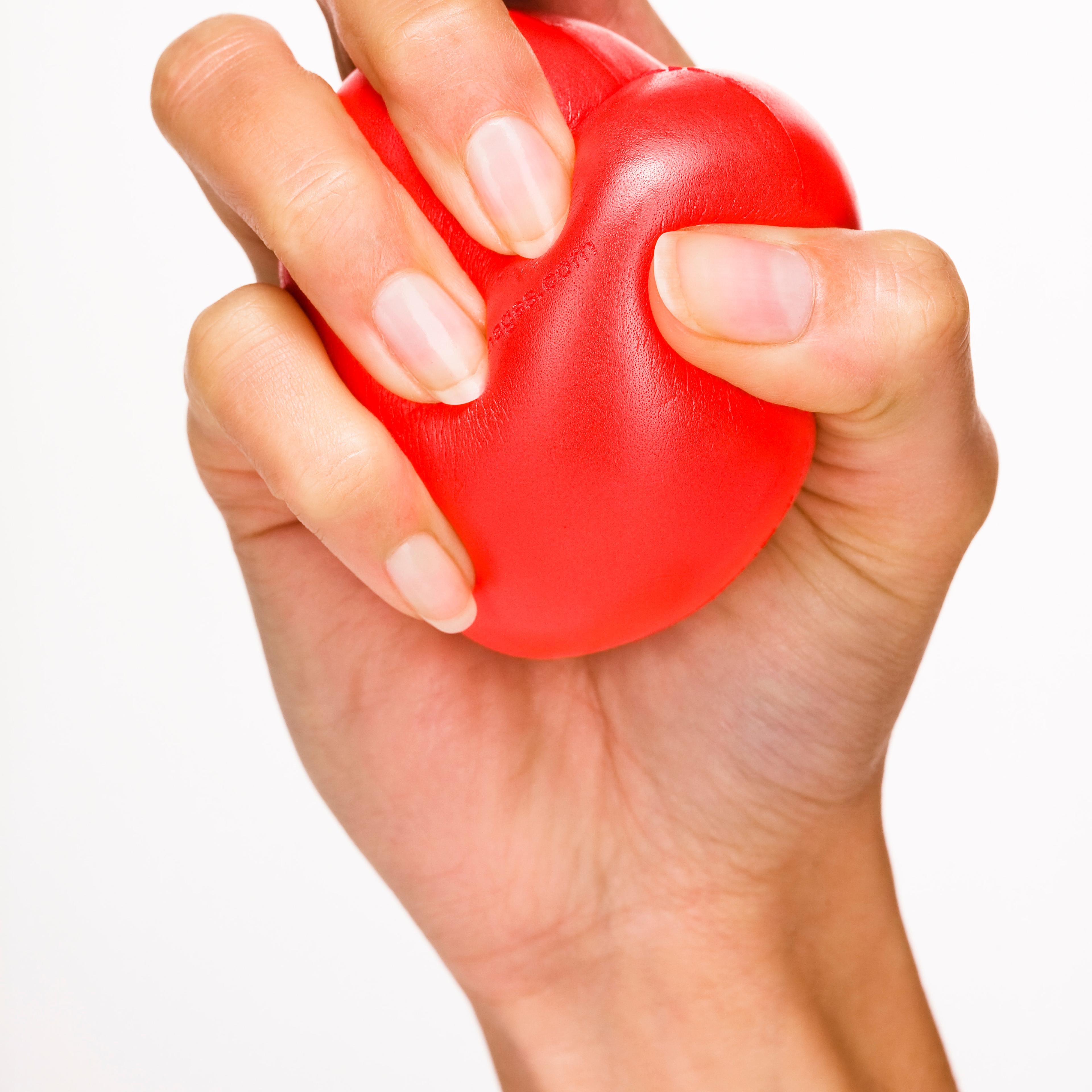 Woman's hand holding red plastic heart