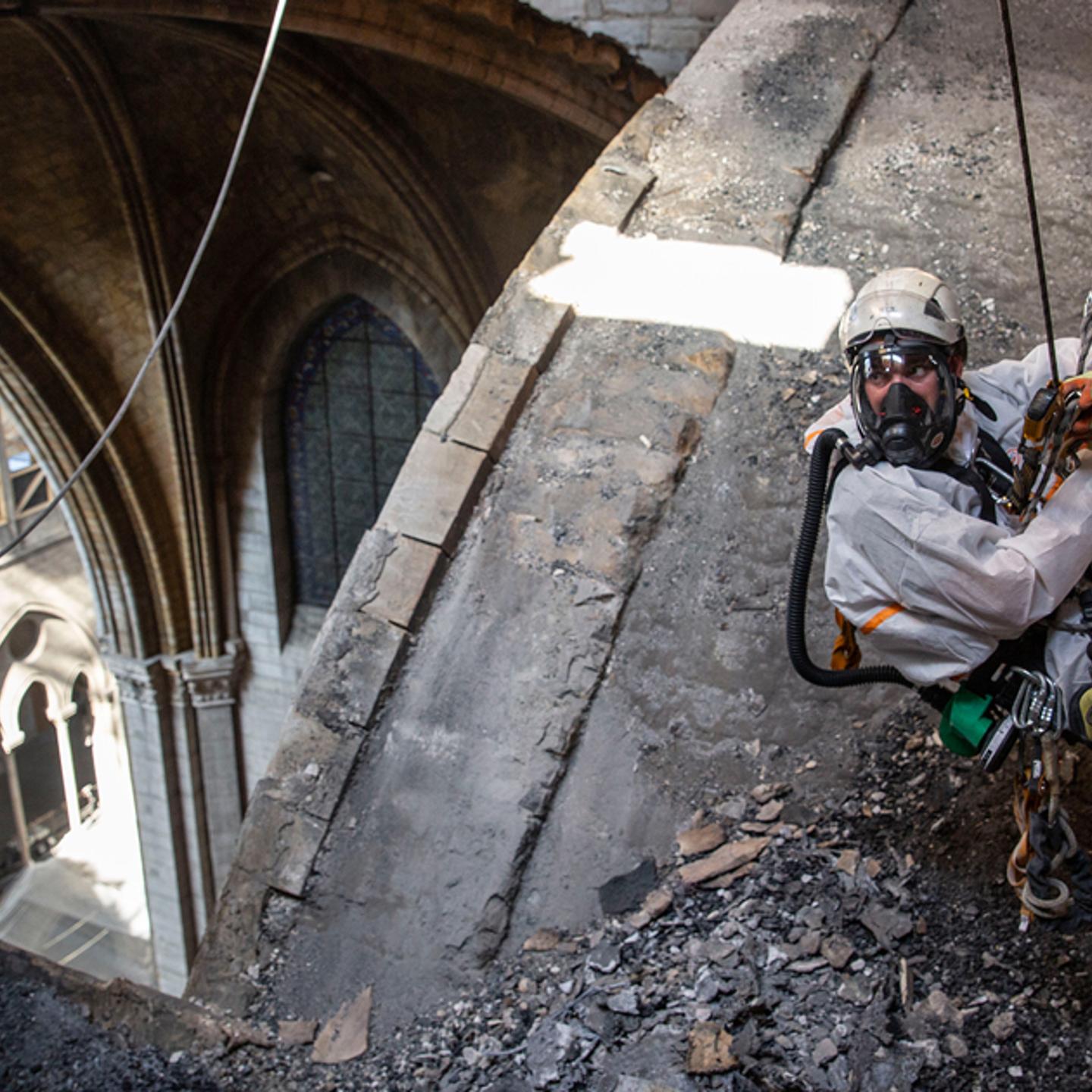 A technician near an open part of the roof on June 25. Some sections of the cathedral have since been exposed to rainfall and high temperatures that France has experienced.