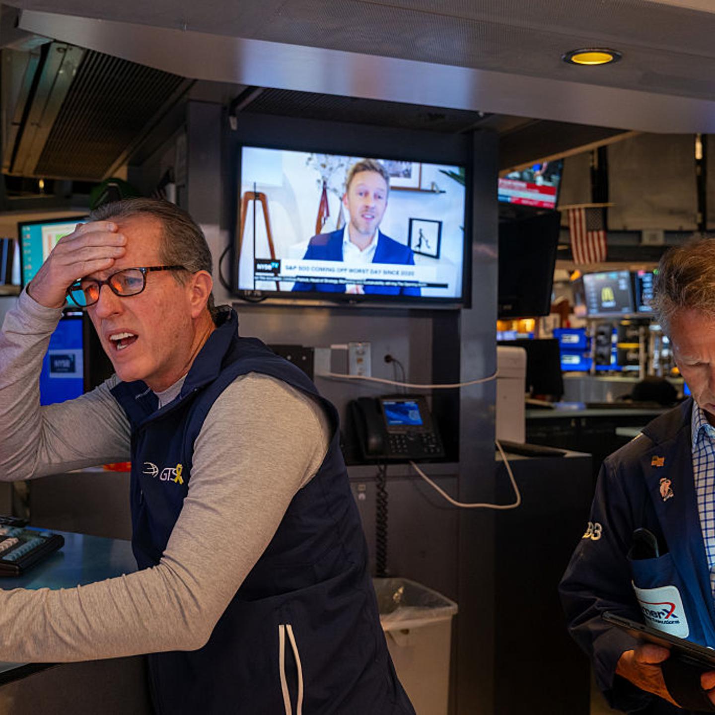 Traders look concerned as the New York Stock Exchange opens after Trump's tariffs sank markets on Thursday