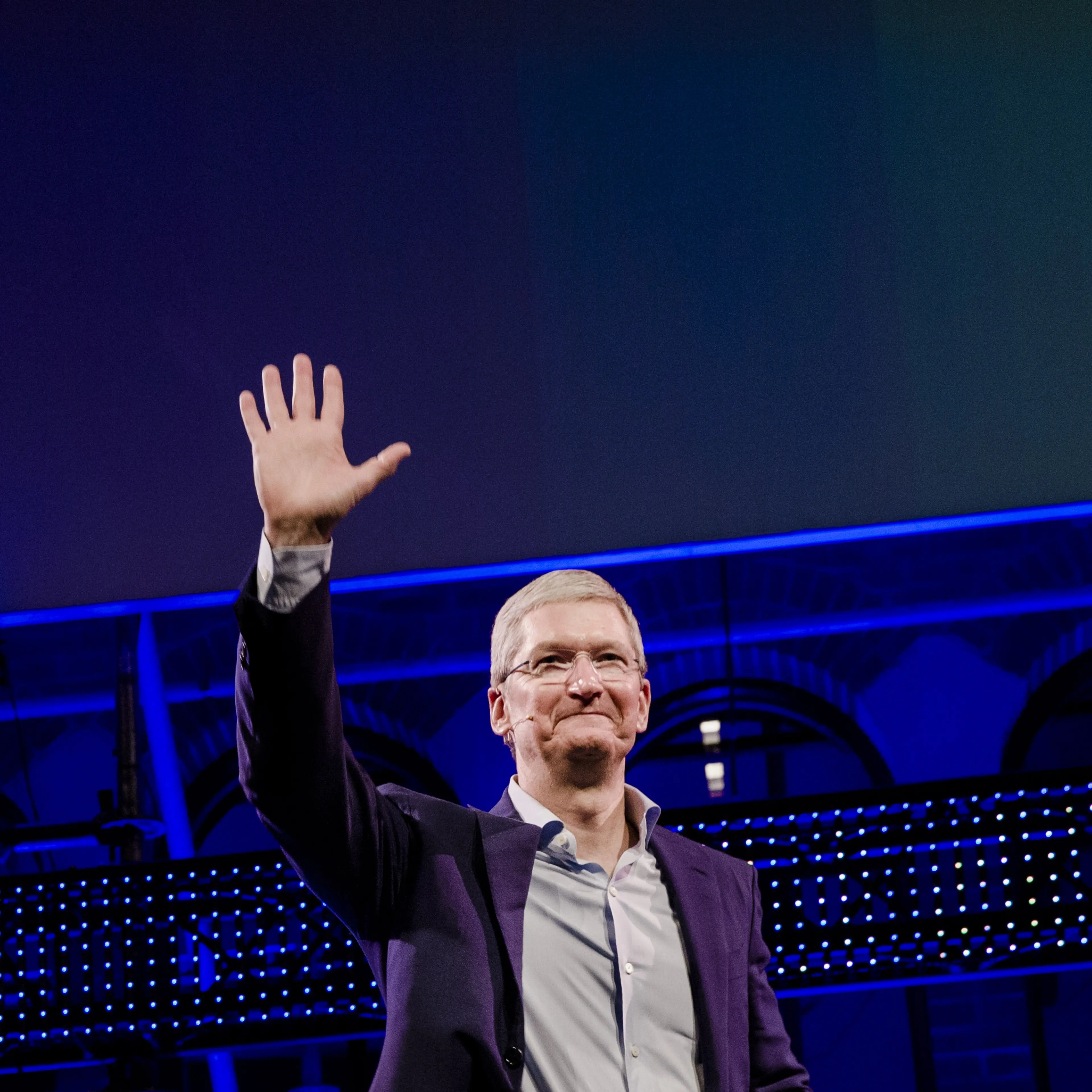 Tim Cook, chief executive officer of Apple Inc., waves to the audience during the opening of "Startup Fest", a five-day conference to showcase Dutch innovation, in Amsterdam, Netherlands, on Tuesday, May 24, 2016.