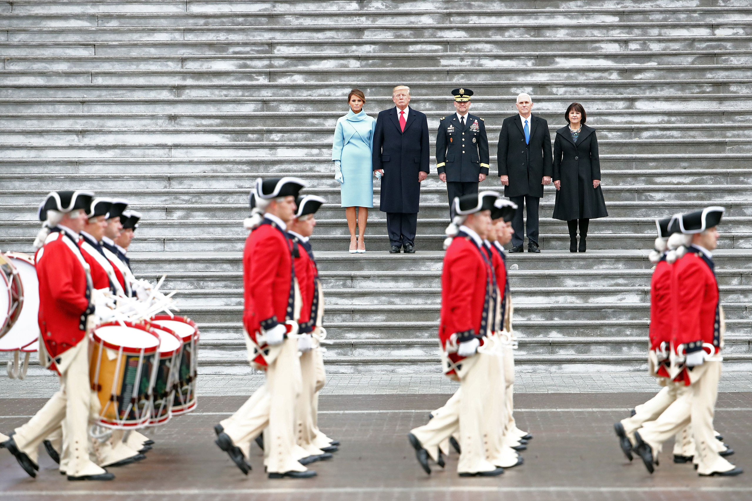 WASHINGTON, DC - JANUARY 20: U.S. President Donald Trump (2L), with (L-R) first lady Melania Trump, Maj. Gen. Bradley Becker, Vice President Mike Pence and his wife Karen Pence review troops on the East Front of the U.S. Capitol on January 20, 2017 in Wa