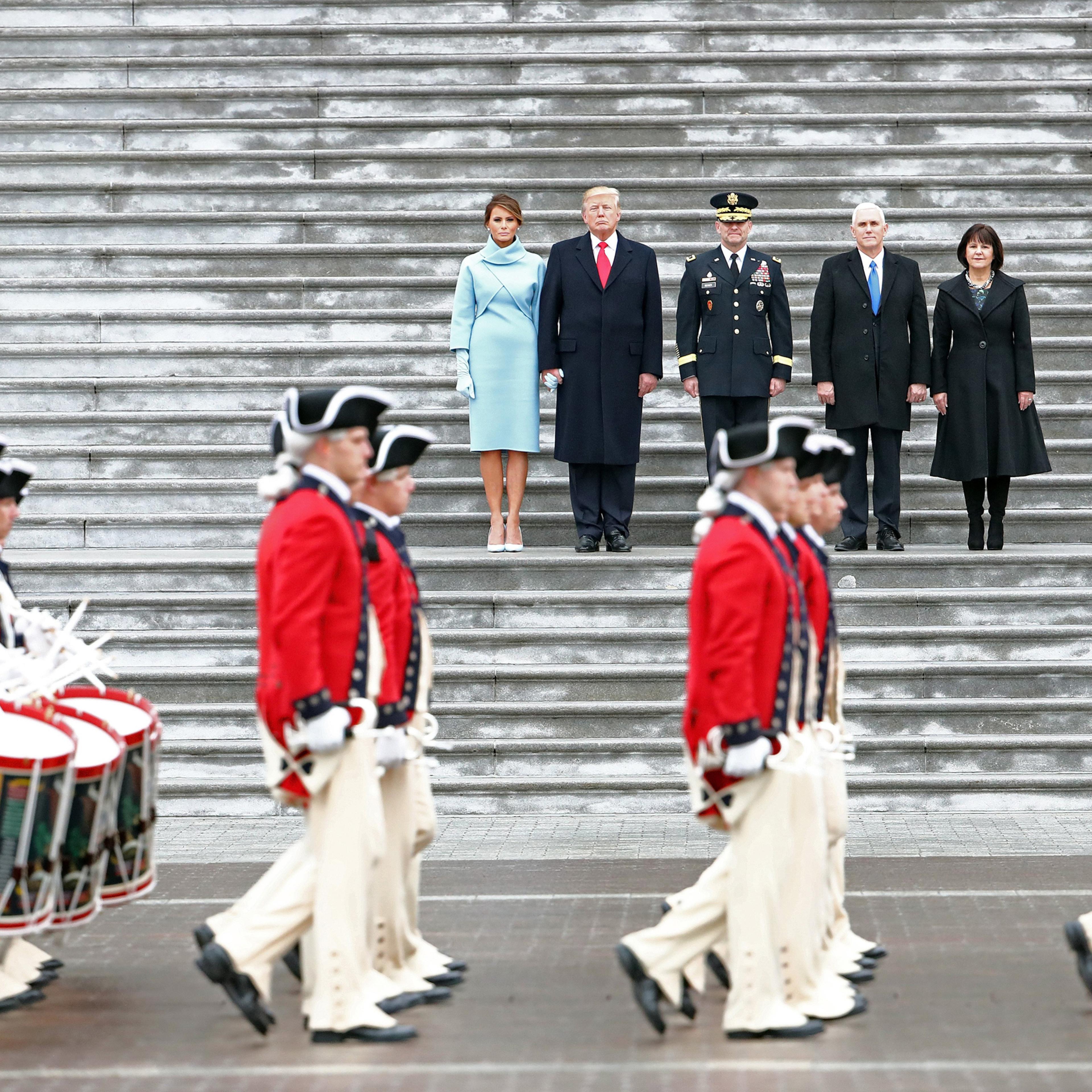 WASHINGTON, DC - JANUARY 20: U.S. President Donald Trump (2L), with (L-R) first lady Melania Trump, Maj. Gen. Bradley Becker, Vice President Mike Pence and his wife Karen Pence review troops on the East Front of the U.S. Capitol on January 20, 2017 in Wa