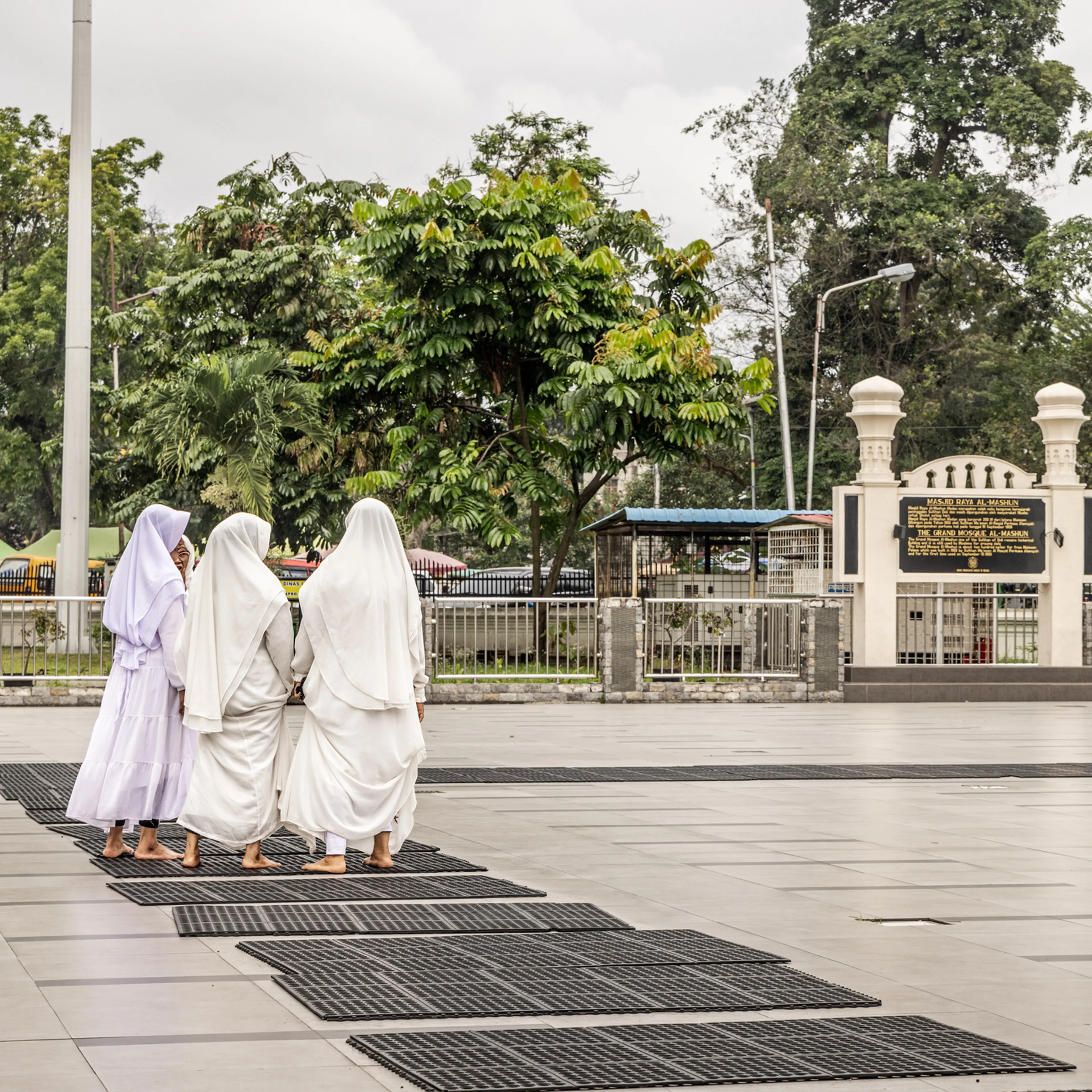 Women walking in the central yard in front of a mosque in Medan, Indonesia, on Jan. 16, 2024.
