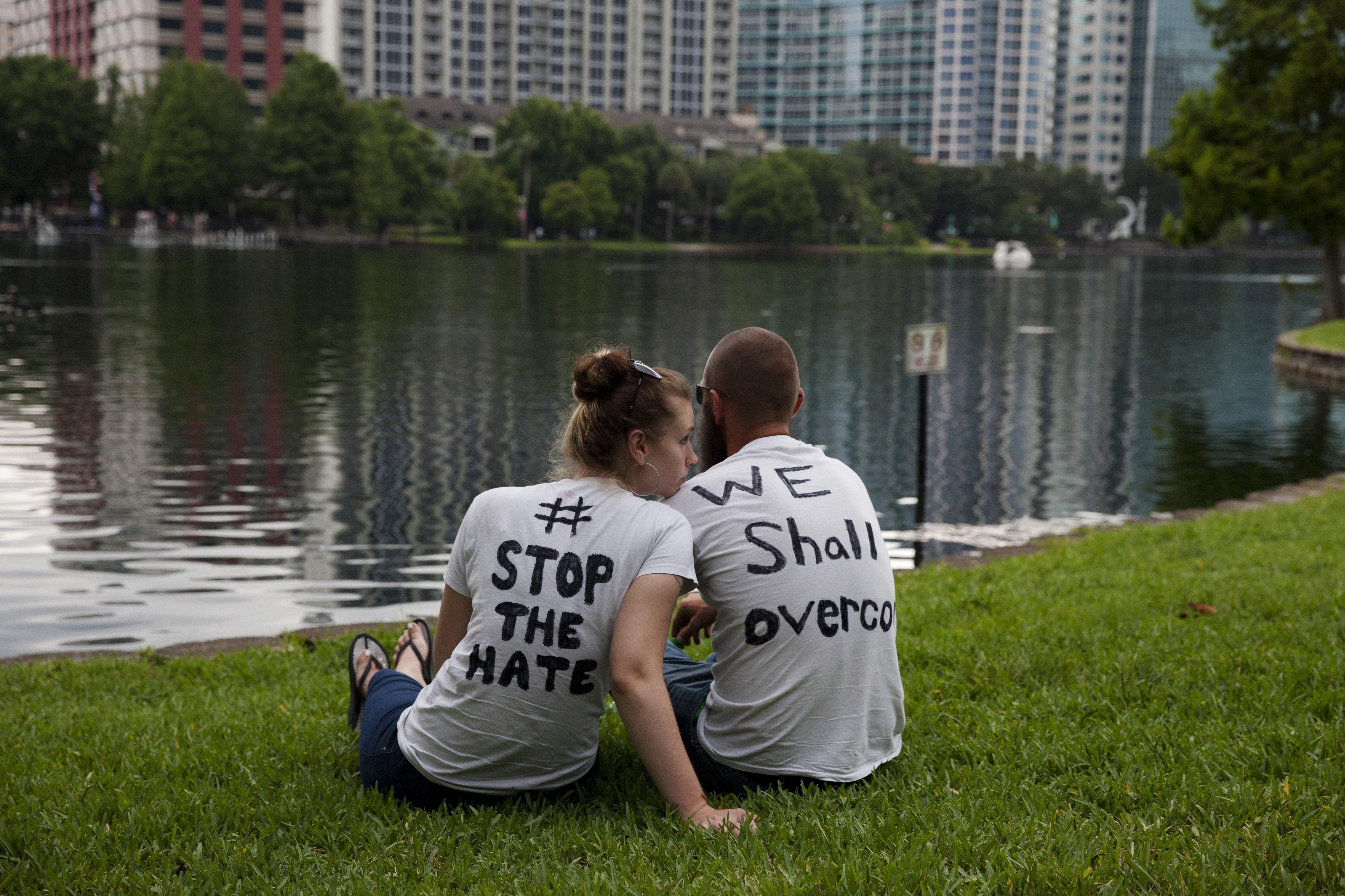Mourners attend a makeshift vigil and a moment of silence for victims of the mass shooting in Orlando, Fla., on June 12, 2016.