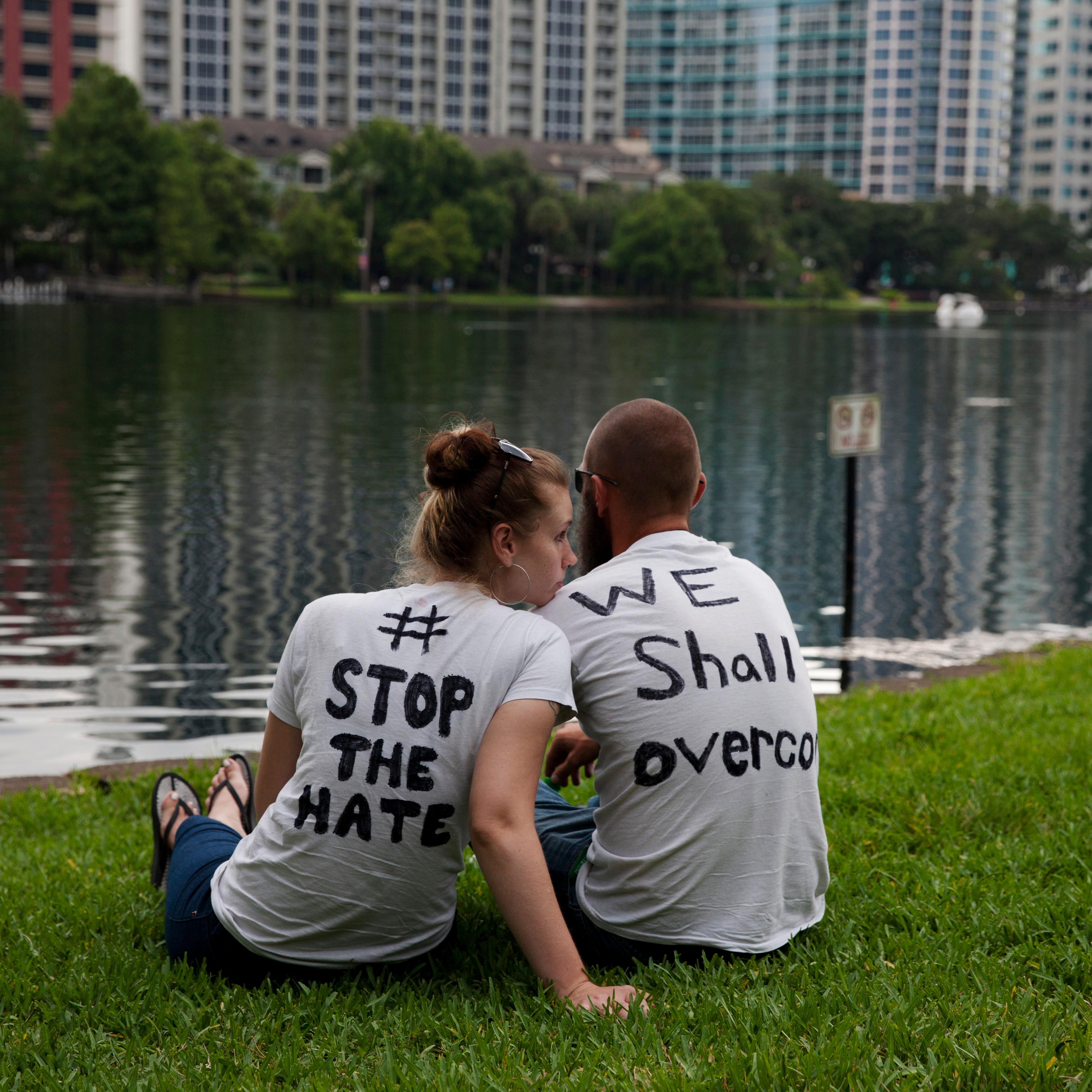 Mourners attend a makeshift vigil and a moment of silence for victims of the mass shooting in Orlando, Fla., on June 12, 2016.